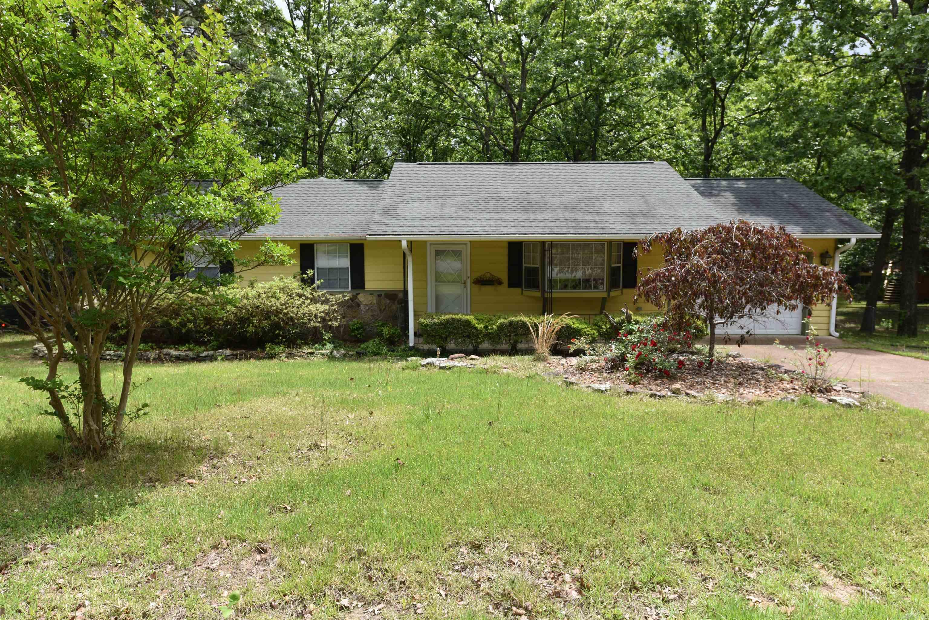 Centrally located on a large corner lot with a fenced back yard, this home is move in ready. Some features include an extra driveway with ample parking for your boat or camper, an oversized screened in porch, a den off the kitchen with a cozy fireplace, bay window in the living room, and more. The main bedroom has a walk-in shower, and the 3rd bedroom could be used as an office. The garage has extra storage. Close to all the amenities in picturesque Fairfield Bay, among them are three swimming pools, two golf courses, ATV trails, a full-service marina, pickle ball & tennis courts just to mention a few. All of this only a short distance away from beautiful Greers Ferry Lake. The chimney was inspected and cleaned October 2024. Some furniture can convey.