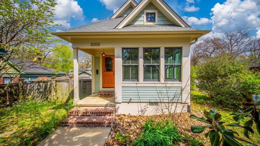 Stop scrolling — this one is special. 5100 Lee Ave is a beautifully renovated cottage-style home in Little Rock that looks and feels brand new. From the bold orange front door and covered front porch to the designer details inside, every inch of this home was crafted with intention. Inside you'll find warm hardwood floors throughout, a stunning white kitchen with solid surface countertops, stainless steel appliances, gas range, subway tile backsplash, under-cabinet lighting, and glass-front cabinetry. The renovated bath features a walk-in tile shower with honeycomb floor detail. Unique touches like a botanical wallpapered ceiling, shiplap accents, and color-drenched ceilings make this home truly one of a kind. Garage plus additional off-street parking. Fully privacy fenced yard. Washer & dryer included. Move-in ready. Homes like this don't last.