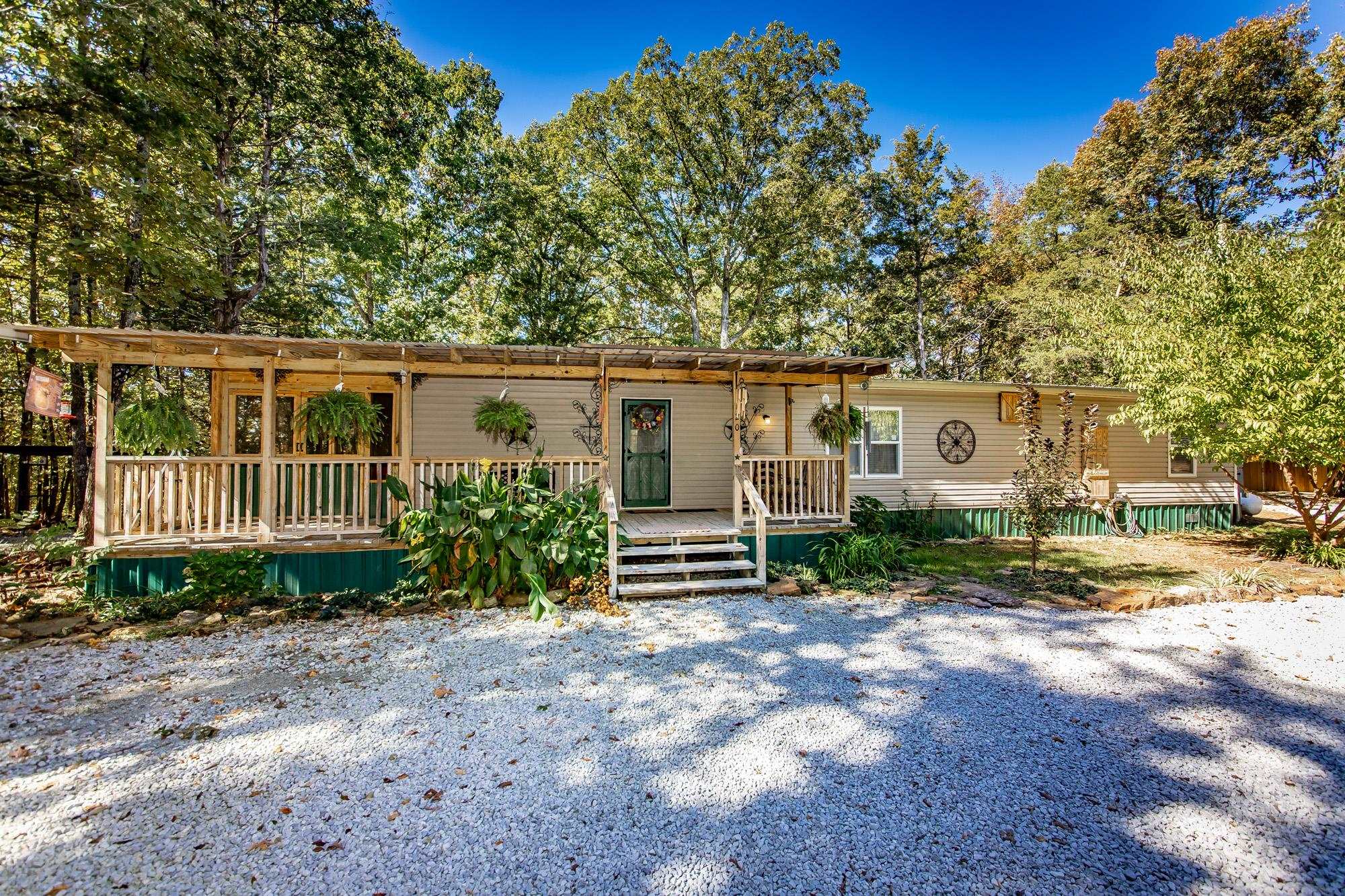 Escape to your own private oasis with this beautifully updated 3-bedroom, 2-bathroom mobile home, attached with hurricane ties, perfectly nestled on 9.2 breathtaking, wooded acres. Located just minutes from the lake, this property offers the ultimate blend of peaceful seclusion and easy access to recreation. Spanning approximately 1,600 sq ft, the home features a bright, open-concept living area with newer flooring and modern updates throughout. Heat is provided by propane wall heaters. The comfortable layout includes three generous bedrooms and two full bathrooms, providing ample space for family, guests, or a home office. Step outside to enjoy a large screened porch and expansive decks, perfect for relaxing or entertaining while soaking in the serene natural views. The 9.2-acre property is a nature lover's paradise, offering ultimate privacy, mature woods, private walking trails, and even a seasonal creek. Whether you're looking for a private homestead, a weekend escape, or a vacation retreat, this move-in-ready home is a rare opportunity. Don't miss this chance to own a slice of country paradise with substantial acreage in a prime lake-area location. Schedule your showing today!