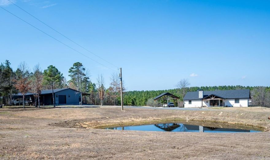 This stunning brick home offers the perfect blend of modern luxury & peaceful country living. Step inside to find quality craftsmanship throughout, including custom cabinetry w/pull-out storage. Quartz countertops in the kitchen, bathrooms & walk-in pantry. The open living area centers around a stunning stone, wood-burning fireplace. The kitchen features a 48" dual-fuel range & stainless-steel appliances. Both bedrooms offer spacious walk-in closets & each bathroom includes fully tiled showers, w/the primary suite boasting an impressive walk-in shower. Tankless gas water heater for efficiency. Gable covered 10x20 front porch with an expansive 8x60 gable covered back porch, and a 24x24 attached covered carport, all accented w/ Douglas Fir posts. The home is equipped w/electric, gas & wood-burning capabilities for versatile living. In addition to the main home, the property features a shop w/12-foot walls & spray foam insulation. Includes a fully operational kitchen, 2 bedrooms, bathroom w/custom tiled shower, washer/dryer hookup, water heater, custom shelving & 14 ft full-length awnings on both sides of shop. Two RV hookups & an 18x40 RV carport. Separate septic system from house.