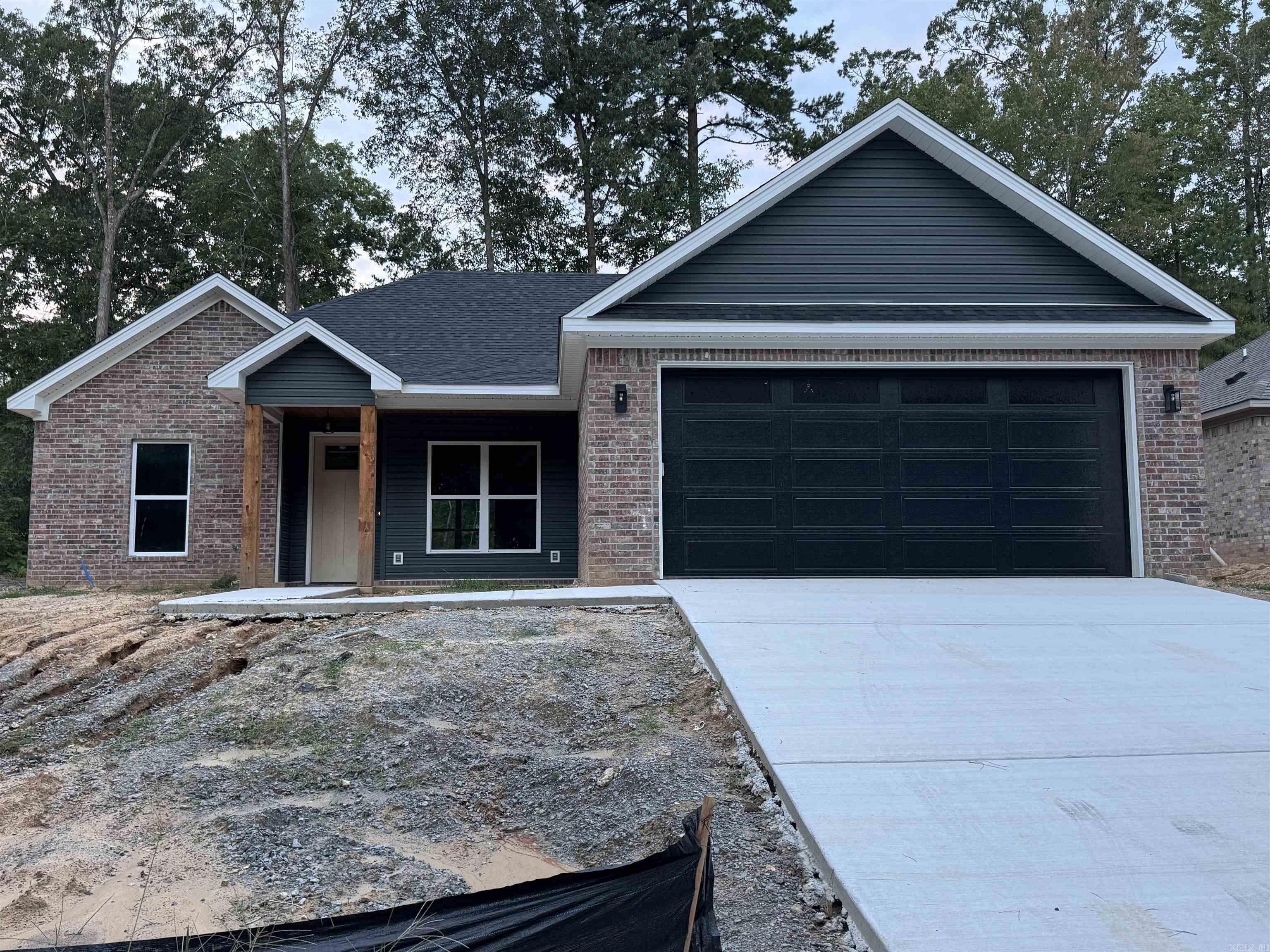 Brand New Construction in the Heart of Benton! This beautifully crafted 3-bedroom, 2-bath home offers modern living with the charm of custom finishes throughout. Conveniently located with easy access to shopping, dining, and top-rated schools, this home features an open-concept layout, luxury vinyl plank flooring, and a stylish kitchen with granite countertops and stainless steel appliances. The primary suite boasts a spacious walk-in closet and a spa-like bathroom with a custom tile shower. Enjoy an endless supply of hot water with the tankless water heater. Come home to quiet evenings on the covered back patio and low-maintenance living in a growing community. Move-in ready and waiting for you to call it home!