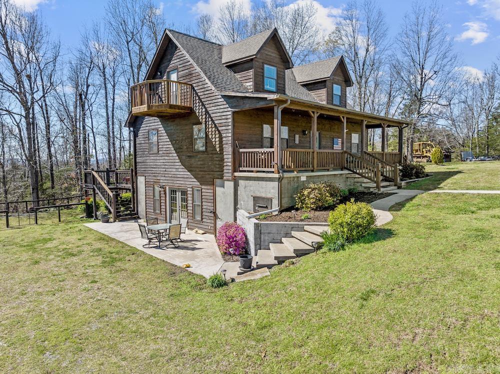 What a spectacular custom home on a quaint and stunning tract with highway frontage, a large shop, and close to the National Forest! You just found one heck of an Ozark masterpiece in the middle of the wooded hill country near the Buffalo National River and Blanchard Springs Cavern. Turning into the property, you immediately have the incredible concrete block 30X50 shop with two large overhead doors, electric concrete floors, a custom bar, a stereo system, and a truck lift! This shop has been landscaped and painted and is set up ready for all your hobbies. Driving up to the home, more wonderful landscaping complements the wood siding and large covered front porch with dual swings. The backyard is fenced, sports a large back deck, and is ready for entertainment for friends, family, and your furry friends. A large concrete patio also sets off the walkout basement for easy access and even more entertainment space. You know instantly that you are home when you walk through the front door. The space is just right but not too large. The open living room/dining area is the ideal balance of cozy yet comfortable, and the kitchen is very spacious.