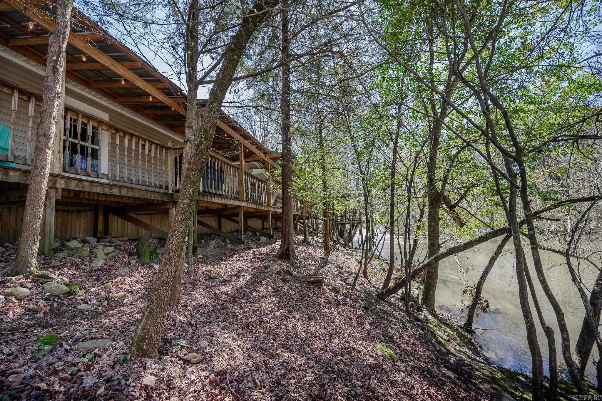 2 Homes on 11.2 Acres WITH Approximately 880' of Irons Fork River Front!! The Glass House Retreat is Up for Grabs!! This is a Very Successful VRBO/AirBNB!! The Glass House Retreat is 1,157 square feet with 2 Bedrooms, and 2 Bathrooms, with a Deck that Overlooks Irons Fork River!! The Glass House Retreat will come Fully Furnished - Turn Key Ready for You!! It Also Currently has Bookings!! Those Bookings will transfer to New Owner. This property Includes a 2nd Home that is a 1,920 square foot, 3 Bedroom, 2 Bathroom Custom Double Wide Mobile Home with a New Roof!! All on 11.2 Acres!! The Views of the River from the Decks of Each of these Homes are Amazing!! And The Garden around the Glass House Retreat is like being in a Secret Garden with Moss Covered Walking Paths!! Beautiful Year-Round Blooms come from the Exquisite Landscaping!! The Main House also has a Whole Home Generator and a Detached 2 Car Shop that has a Tornado Shelter in it!! There is also an additional Workshop and Multiple Out-Buildings! This Property is a MUST SEE with too many features to list here!! There is Plenty of Opportunity to Expand on this Property and make it a Resort Style Property!!