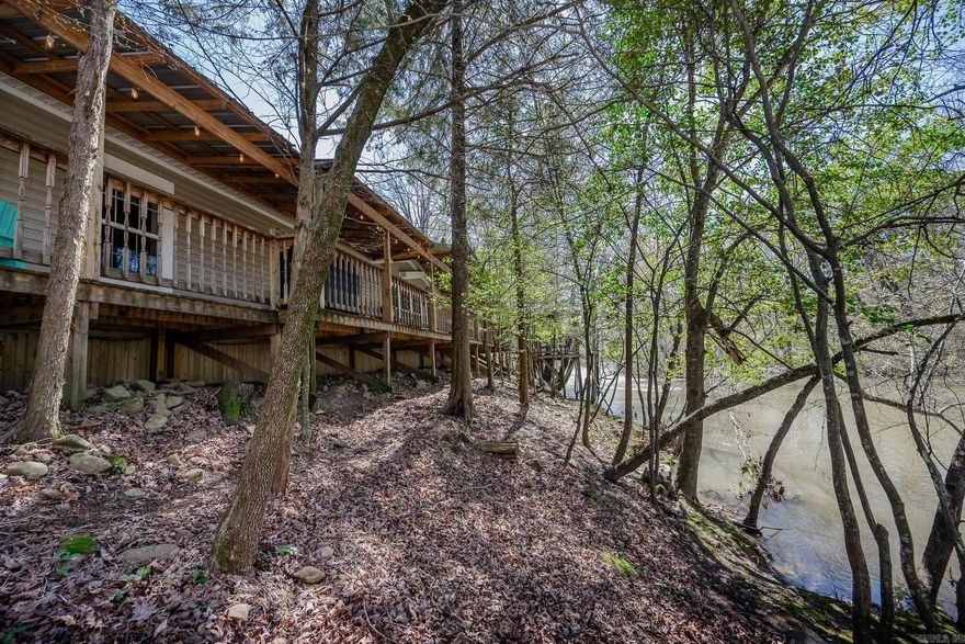 2 Homes on 11.2 Acres WITH Approximately 880' of Irons Fork River Front!! The Glass House Retreat is Up for Grabs!!  This is a Very Successful VRBO/AirBNB!!  The Glass House Retreat is 1,157 square feet with 2 Bedrooms, and 2 Bathrooms, with a Deck that Overlooks Irons Fork River!!  The Glass House Retreat will come Fully Furnished - Turn Key Ready for You!! It Also Currently has Bookings!!  Those Bookings will transfer to New Owner. This property Includes a 2nd Home that is a 1,920 square foot, 3 Bedroom, 2 Bathroom Custom Double Wide Mobile Home with a New Roof!! All on 11.2 Acres!! The Views of the River from the Decks of Each of these Homes are Amazing!! And The Garden around the Glass House Retreat is like being in a Secret Garden with Moss Covered Walking Paths!!  Beautiful Year-Round Blooms come from the Exquisite Landscaping!! The Main House also has a Whole Home Generator and a Detached 2 Car Shop that has a Tornado Shelter in it!! There is also an additional Workshop and Multiple Out-Buildings!  This Property is a MUST SEE with too many features to list here!!  There is Plenty of Opportunity to Expand on this Property and make it a Resort Style Property!!
