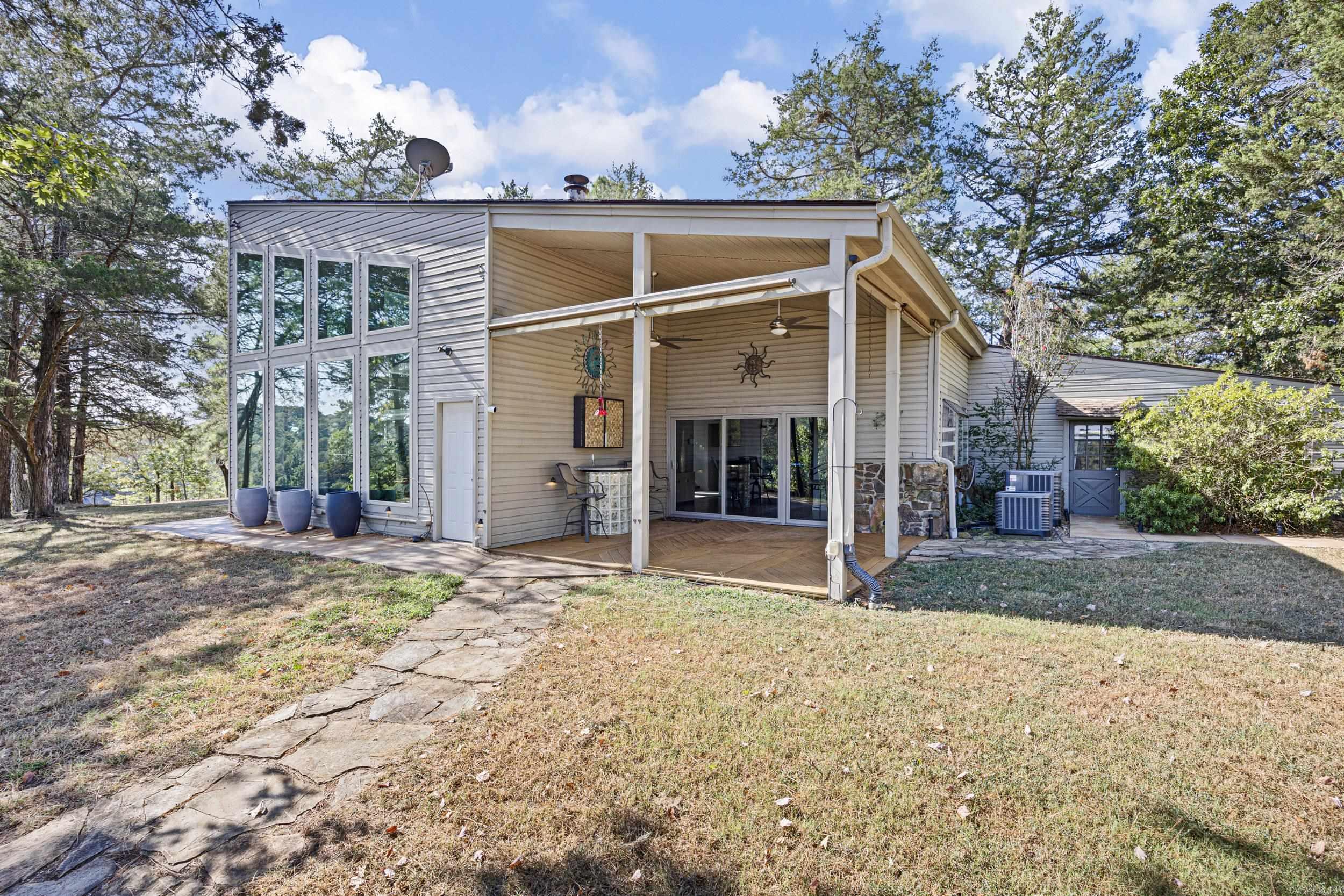 Spacious Home with Stunning WATER VIEW on Over 8 Acres!! This beautiful home boasting over 2600 sq feet, offers space, charm, and incredible views overlooking Piney Bay Creek. Nestled on just over 8 acres, the property provides privacy, comfort, and unique features that make it truly one of a kind. Inside, youāll find 2 bedrooms (one upstairs and one downstairs) and 2 bathrooms. The living room is anchored by a striking floor-to-ceiling marble fireplace for a cozy feel. A queen-size Murphy bed, four (4) flatscreen TVs, and all appliances (including washer and dryer) convey, along with some furnishings, making this home move-in ready. Additional highlights include: ⢠Detached 2-car garage ⢠Detached 784 sq. ft. garage/workshop with HVAC ā perfect for hobbies, a studio, or extra storage ⢠Operational well with 40 PSI pressure ⢠Expansive acreage with amazing water views of Piney Bay Creek With its spacious layout, modern conveniences, and serene waterfront setting, this property is ideal as a full-time residence, weekend escape, or investment opportunity. It is gated entry and smart cameras! 2 AC units less than 2 years old! 2 Water heaters! Call today!!