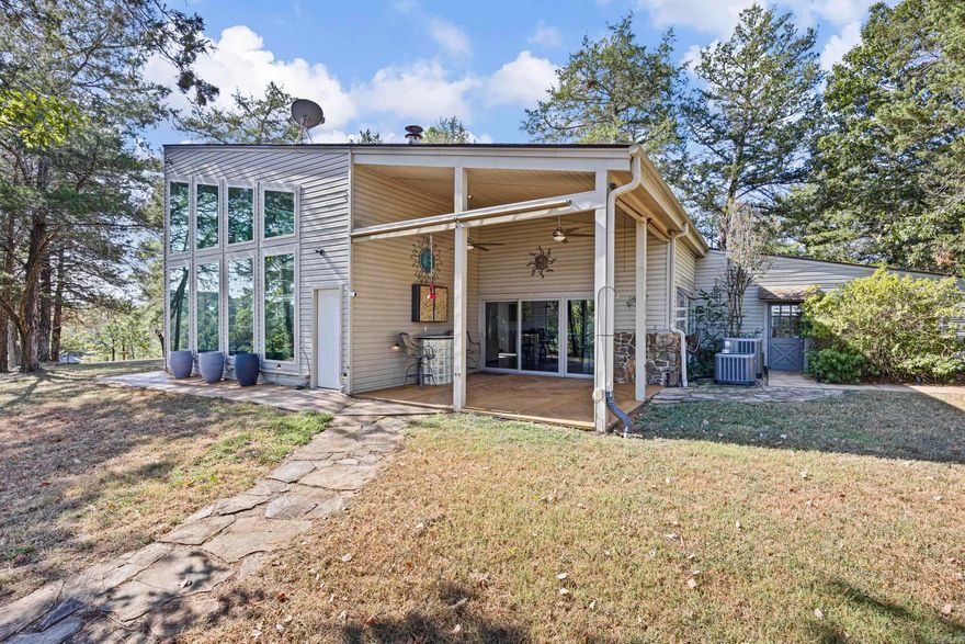 Spacious Home with Stunning WATER VIEW on Over 8 Acres!!  This beautiful home boasting over 2600 sq feet, offers space, charm, and incredible views overlooking Piney Bay Creek. Nestled on just over 8 acres, the property provides privacy, comfort, and unique features that make it truly one of a kind.  Inside, you’ll find 2 bedrooms (one upstairs and one downstairs) and 2 bathrooms. The living room is anchored by a striking floor-to-ceiling marble fireplace for a cozy feel. A queen-size Murphy bed, four (4) flatscreen TVs, and all appliances (including washer and dryer) convey, along with some furnishings, making this home move-in ready.  Additional highlights include:  • Detached 2-car garage  • Detached 784 sq. ft. garage/workshop with HVAC – perfect for hobbies, a studio, or extra storage  • Operational well with 40 PSI pressure  • Expansive acreage with amazing water views of Piney Bay Creek  With its spacious layout, modern conveniences, and serene waterfront setting, this property is ideal as a full-time residence, weekend escape, or investment opportunity. It is gated entry and smart cameras! 2 AC units less than 2 years old! 2 Water heaters! Call today!!