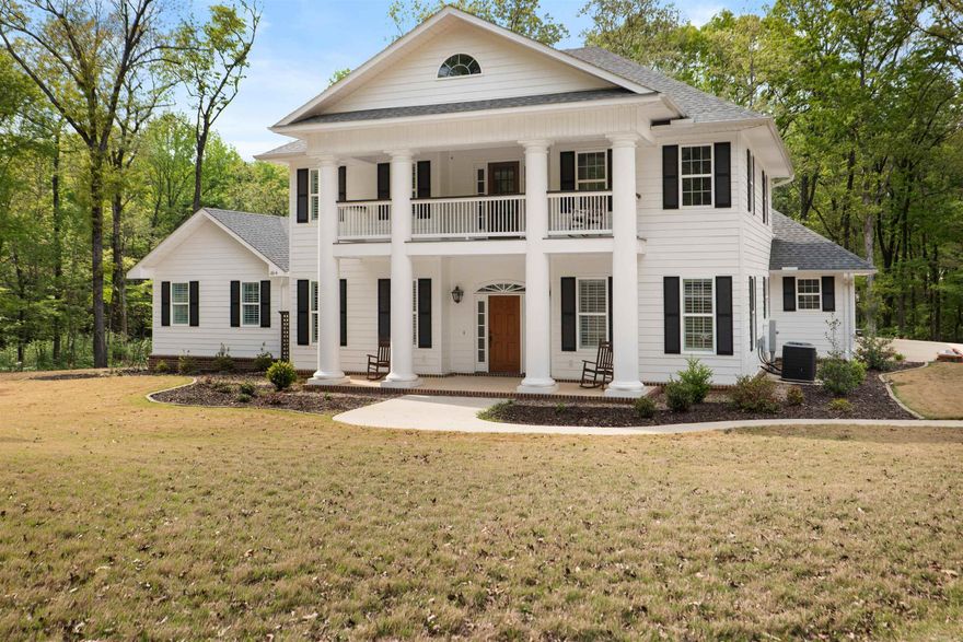 4 beds | 3.5 baths | 3,194 sqft | 6.6 acres | Built 2023 | Valley View Schools This incredible estate, inspired by the historic homes of Natchez, Mississippi, is tucked away just inside the heart of the city and offers a newer home on 6.6 wooded acres right off Southwest Drive. It is close to town but set back in a private, wooded setting. The main level includes a primary ensuite with its own marble-surround fireplace, a dedicated office with custom built-ins, formal dining, and a central living area anchored by a second marble-surround fireplace. The kitchen is designed for both daily use and entertaining, with custom cabinetry and top of the line appliances. Just off the laundry room, you'll find a built-in, fully tiled dog wash station. Upstairs features a second living area, three additional bedrooms, and two full baths, providing separation and flexibility. Additional features include a walk-in concrete safe room located off the attached garage with space for two vehicles and a UTV or other equipment, and a detached 550 square foot heated and cooled workshop with its own covered patio. The covered back porch overlooks large fenced yard, w wooded acreage and a natural buffer.