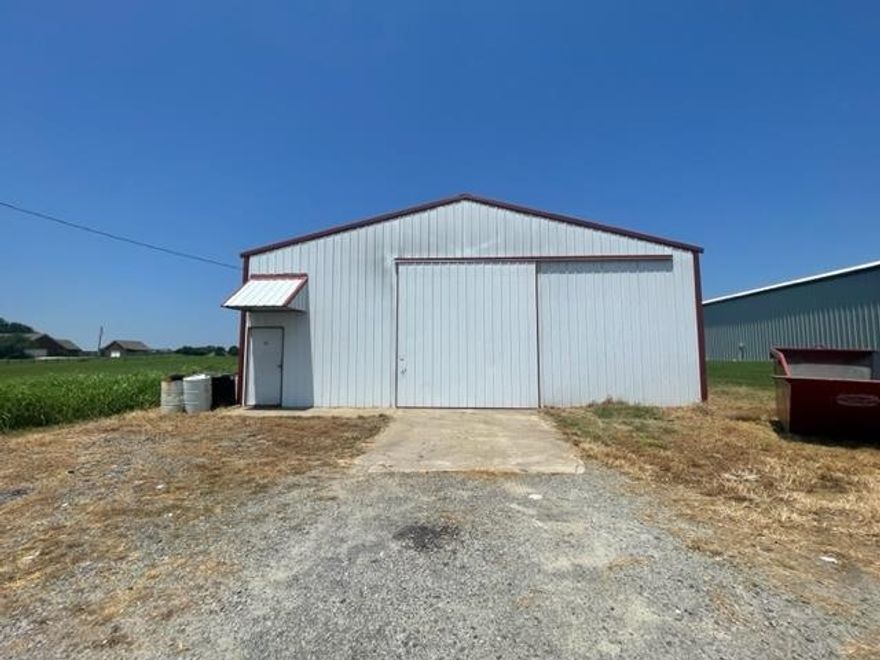 Great warehouse space fully insulated with foam. Even on 100 degree days it is comfortable inside. Small office space 10x15. Storage area is the same size as the office. Large barn door 11 1/2 wide by 13 tall. The main acreage is across the street with a gravel parking area. These 2 acres are directly behind the Dollar General with road access to Hwy 25 beside Dollar General. You can use this 2 acre parcel and have direct access to Hwy 25. This land is highly visible from Hwy 25. Currently leased and tenant is willing to stay.
