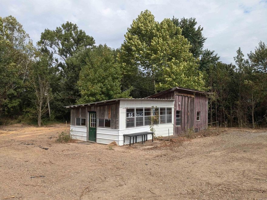 Welcome to 6303 S Highway 23 in Ozark, Arkansas – a rare opportunity to own a private, gated property featuring 7.59 acres of versatile land with highway frontage. This expansive property includes two separate lots, offering endless potential for both business and residential use. The multi-use building, complete with power, sits on the frontage lot, which has been graded and cleared, making it ready for your next venture. Previously a nursery and greenhouse, this property is perfect for those looking to start a new business, build their dream home, or invest in prime land.  The second lot is accessible via a concrete easement drive and features a beautiful forested landscape, offering privacy and natural beauty. With no restrictions, the possibilities are endless – whether you're dreaming of a country retreat, planning a new business, or seeking a peaceful homestead, this property can make your vision a reality.  Don't miss this chance to own a piece of Ozark paradise. Owner Financing Available. GPS 35.3979, -93.84343