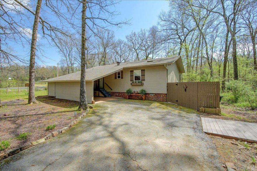 Come live & play in Diamondhead. This home has been recently updated with premium quality flooring and fixtures with a year-round peaceful running creek through the property & views of the 4th greens on the golf course! Open Kitchen/Living room with vaulted ceilings & solid wood beams in living area. Kitchen has state of the art petrified leather granite & pantry behind the barn doors. Both baths have been remodeled beautifully with the master designed with a rain head shower system.  Master suite is designed with a private sitting area.  Diamondhead is a friendly community only minutes from downtown Hot Springs & racetrack.  It includes a PGA sanctioned golf course, Olympic size swimming pool, children's playground, tennis, basketball & pickleball courts, club house, community library, exercise room & lots of friendly neighbors. Bordered by award winning Lake Catherine State Park and peaceful Lake Catherine. All residence have lake access. Your gonna Love it Here!