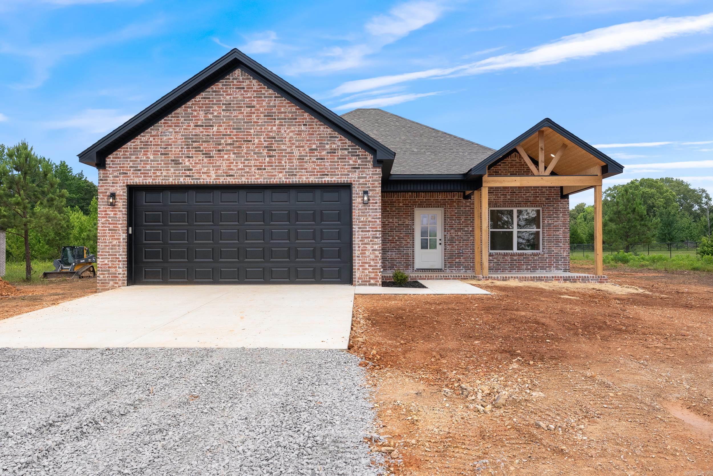 This beautifully crafted home sits on a spacious 1-acre lot and features an inviting open floor plan perfect for modern living. Enjoy durable and stylish LVP flooring throughout the main living areas, a luxurious primary suite complete with a relaxing soaker tub and a sleek walk-in shower, and thoughtful design details at every turn. The welcoming front porch showcases custom woodwork that adds curb appeal and character. Whether you're entertaining indoors or enjoying the peace and privacy of your large yard, this home offers comfort, charm, and functionality in one perfect package. Don't miss your chance to own this stunning property!