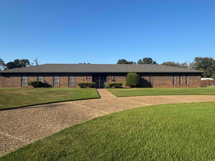 A diamond in the rough!!!  This one owner home sits on 1.1 acres.  One level with  3 BRs with walk-in closets, 4 1/2 baths, office, huge living room and even larger sunroom with tons of windows. The laundry room has storage and a double sink. The primary suite is huge and has a great bathroom with 2 walk in closets, double vanities, tub and shower.  The kitchen is oversized with a breakfast bar, lots of cabinets and storage.  Double door entry to the front is very attractive.  Original home had 3 car garage, 2 additional garages have been added.  One can hold a large boat and the other a large RV.  Roof was just installed last month and recently a new septic system was installed.  Fully fenced with brick and some chainlink. It backs up to woods for privacy.  There is also a storage building. The wheelchair ramp in the living room can easily be removed, you won't even know it was there.  Don't miss this one.