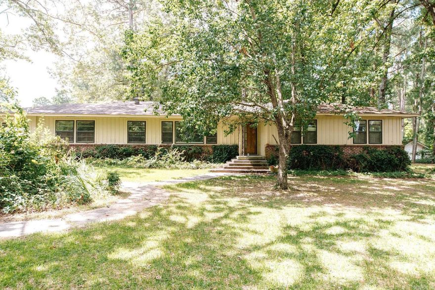 Spacious and well-maintained 4 bedroom, 2bath home nestled on a beautiful 0.79 acre shaded corner lot. With 2,464 sq ft of living space, this home offers comfort, functionality, and room to grow. There is a generous floor plan featuring a large kitchen, with ample cabinetry, and plenty of natural light throughout. 350 sq ft building for guest house, or storage. Call today to make this yours. Home is sold as is.