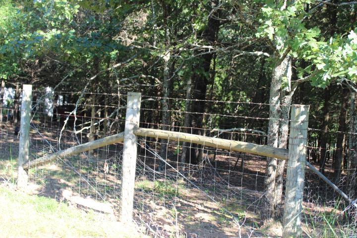 This approximate 5 acre lot is fully fenced with city water, a well, septic and electricity. A perfect place to enjoy all kinds of wildlife! Always waned to raise goats? Bring them on, as the owner found this a perfect place to do so previously. This property is not far from town yet peaceful enough to offer a country setting perfect for unwinding and relaxing. If it's outside fun you crave, four wheeling is right outside your door.There is an approximate 2704 sq ft house that will be sold "AS IS" and will convey at no value. Fix it up it or build your dream home. So much potential awaits the right person to make this awesome property your NEW PLACE TO CALL HOME. ****AGENTS PLEASE SEE REMARK****