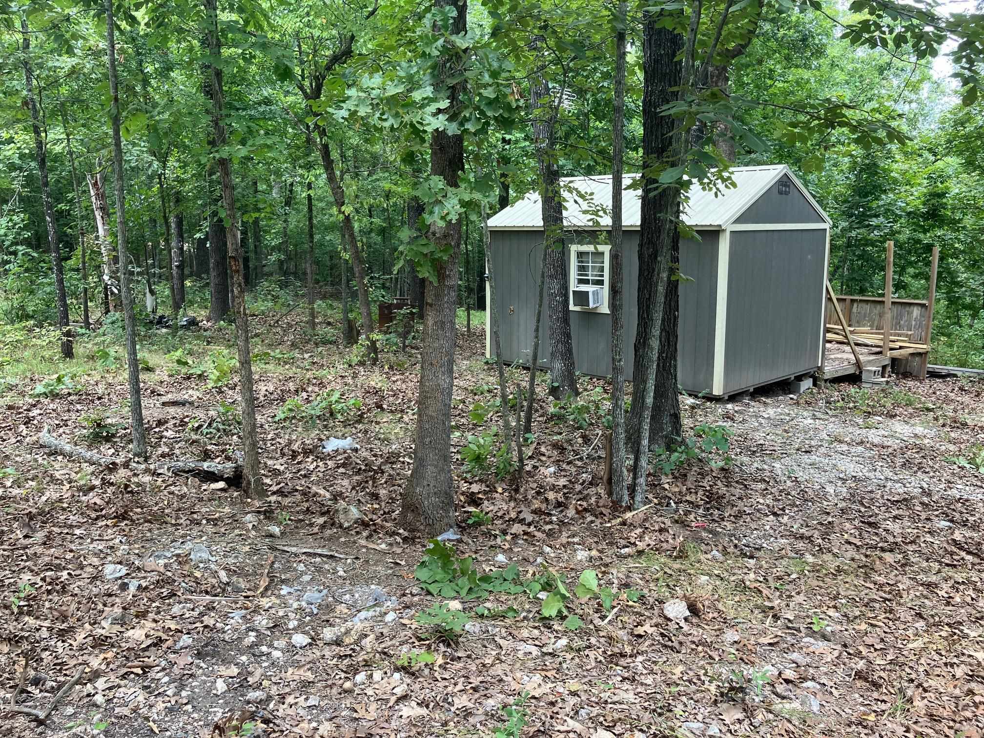 This wooded 6.2 acres m/l has approx. 700 feet of county road frontage. A 12'x15' unfinished cabin with a deck is located on the property in a level spot. The land has good timber and good hunting. The location is close to the Spring River and Myatt Creek. No electricity or water.