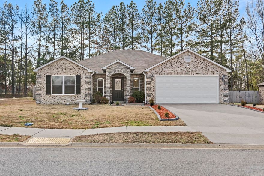 Welcome to 1614 Lil Larry Drive, a charming single-family home nestled in the heart of Cabot, Arkansas. Built in 2019, this residence offers a spacious 1,720 square feet of living space, featuring 4 bedrooms and 2 bathrooms.  The open-concept floor plan is accentuated by 9-10 foot ceilings throughout, creating an airy and inviting atmosphere. The modern kitchen boasts luxury vinyl plank flooring, and stainless steel appliances. A pantry provides ample storage, and the refrigerator stays with the home.  The master suite is a private retreat, featuring a walk-in closet and a master bath with a double vanity and walk-in shower.  Exterior features include a brick and stone facade, a composition roof with 3-tab shingles, and a level corner lot. Located just minutes away from shopping, dining, and entertainment, this home is within the Cabot School District, making it an ideal choice for families. The neighborhood offers a blend of convenience and community, with easy access to local amenities.