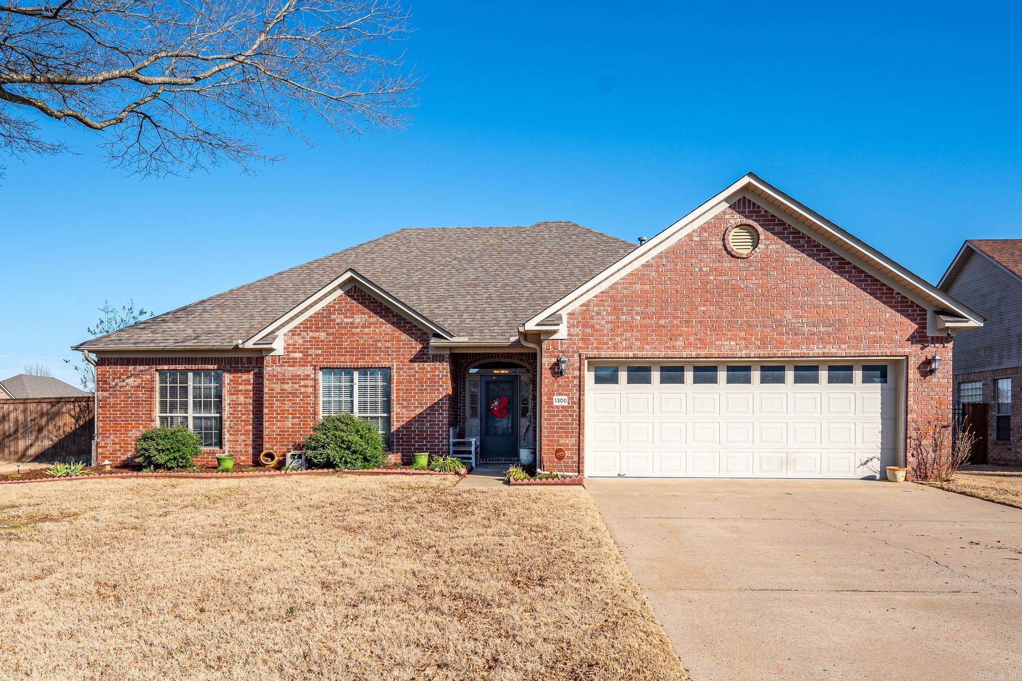 Discover your dream home in the desirable South Wind subdivision! This charming brick house sits on a corner lot with extensive landscaping. Enjoy a large backyard complete with a pergola and a new storage building, perfect for outdoor gatherings and storage needs. Inside, you'll find beautiful handscraped hardwood floors, a spacious laundry room with a sink, and a separate dining room ideal for entertaining. Cozy up by the gas fireplace in the inviting living area. This cute, move-in-ready home is waiting for you!