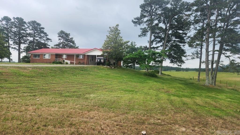 1.54 acres with 1736 sq ft brick home on Murphy Rd in Black Springs AR. 3 bedroom 2 bath built in 1973 has an amazing view out the dining room window. Kitchen recently upgraded with beautiful hickory cabinets. Original oak flooring in some of the rooms. Gas logs in the living room. No restrictions. Has a well and septic. Small generator. Metal roof. New windows about 9 yrs ago. Washer/dryer, refrigerator, dishwasher, and gas cook stove with double oven all convey with the sale. Walk-in tub and wheel chair ramp for easy access. On-demand water heater. 19x22 carport, 20x28 workshop/storage building. Can be purchased with MLS#25019600 to make a total of 18.77 acres. Give us a call for your private showing.