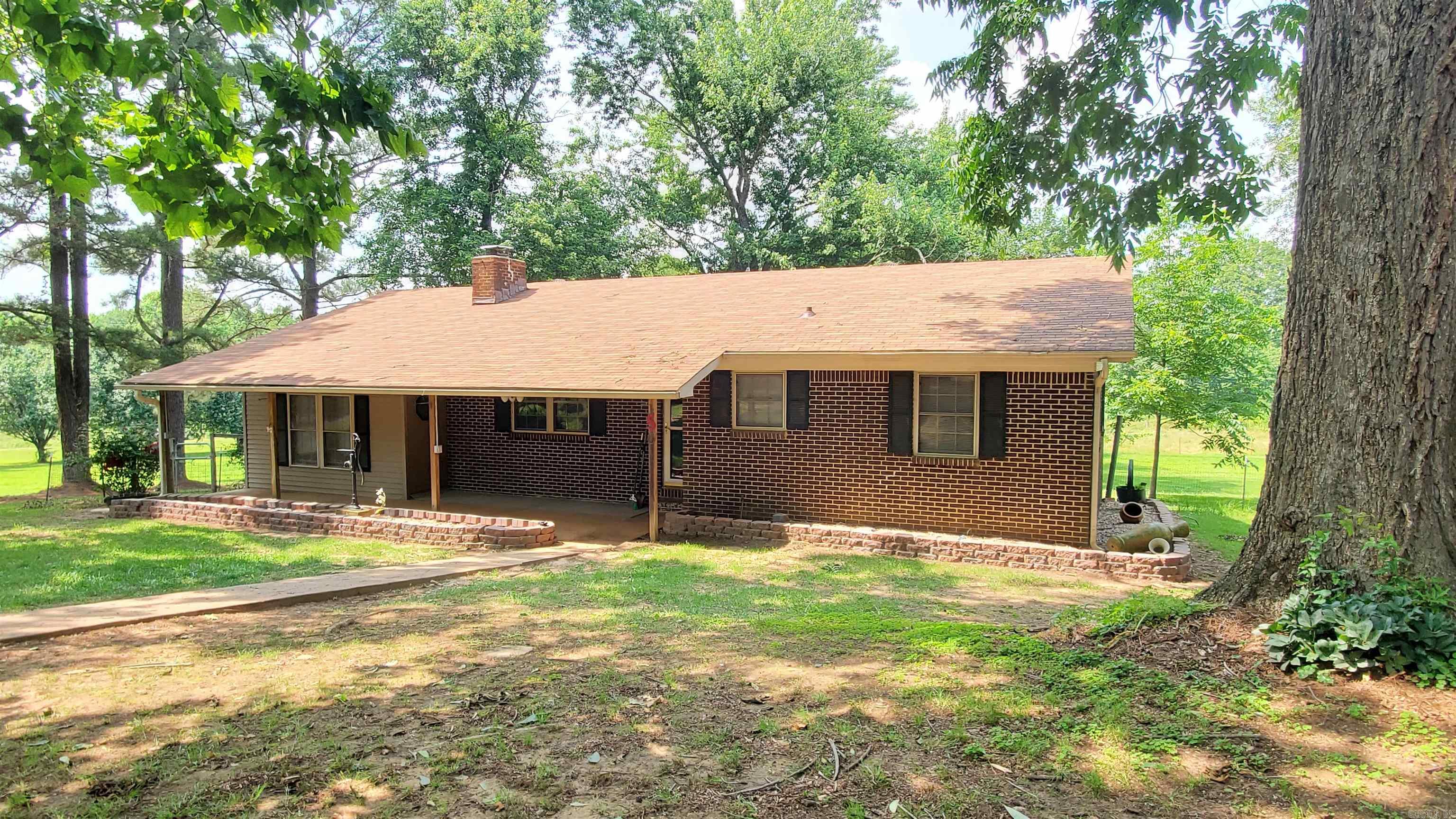 You don't want to miss this Older well maintained home sitting on 2 Beautiful acres on corner lot. Home has been fresh painted recently and newer flooring (no Carpet) Sunroom, 2nd living room or office was added by enclosing a 1 car garage. (could be used for 3rd bedroom if needed) Nice size Kitchen and dinning area, Large Living room with pretty Brick Fireplace, Bedrooms are great size, Master has the 1/2 bath attached to it. This home also has a 20x30 shop for all your storage needs but also has a cute 12 x 24 building that could be used for a man cave or she shed. (Razorback in pictures on this building does not convey). finish this off with awesome landscaping and a nice Storm Shelter. Roof New in 2022, HVAC 7 yrs old, Water heater 2023. Call today to schedule your private showing. House is Sold AS IS except 3rd party repairs will be negotiated.