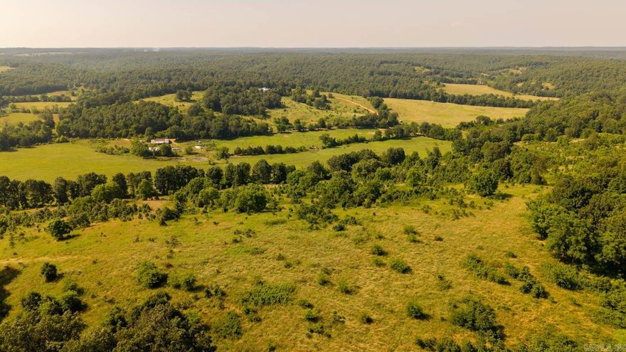 440-Acre Ranch or Hunter’s Retreat – Secluded Ozarks Paradise Discover 440± acres of pristine Ozarks land, ideal for a private retreat, working ranch, or sustainable off-grid living. This secluded property boasts 165± wooded acres and 275± open acres with hayfields, grazing land, and breathtaking views. Enjoy 9 ponds (some stocked), 7 springs, and the South Fork of Martin’s Creek flowing through the land—providing abundant natural beauty and water.  A 4,800 sq ft home with a wraparound porch anchors the estate, featuring a 3 bed, 2 bath layout upstairs and a nearly finished 2 bed, 2 bath space below. Solar panels support energy efficiency and off-grid potential. Fruit trees—apple, pear, peach, and plum—enhance your self-sufficiency, and a greenhouse (needs TLC) extends your growing season.  Two corral setups, fencing and cross-fencing, and a large shop/barn with concrete floors, electric, and water make it turnkey for livestock. Multiple building spots, marketable timber, and unmatched privacy make this a rare opportunity to build your legacy in the Ozarks.