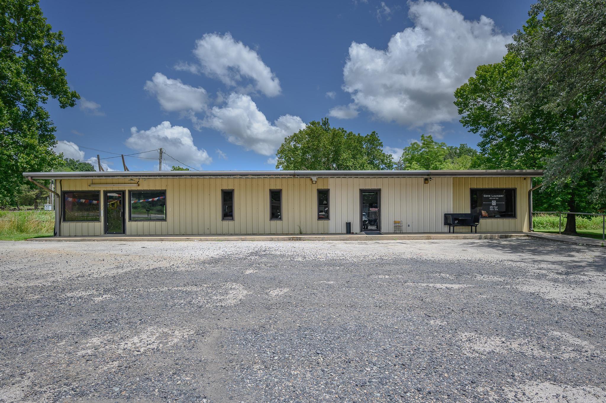 Versatile Commercial Building currently operating as a Laundromat which includes the equipment to continue operations seamlessly. Included: 5 front load & 5 top load washers, 9 dryers, PLUS 3 dryers & 3 washers that were used separately for a laundry service. Tables & chairs. Laundry soap dispenser, change machine, & vending machine that are 6 months old. New plumbing ran for washers. 2 bathrooms. Central heat & air in laundry mat. Mini split & gas heat in office space on left end of the building. In addition to the laundry facilities, the property features multiple office spaces that could be rented out individually, providing additional income potential. High visibility with 110' of Highway 71 frontage. Security system negotiable. Two separate electric accounts with shared gas & water. Located just 3 miles from the Oklahoma line & 14 miles to Mena. Whether you're looking to run your own business or lease out the spaces for rental income, this property offers endless possibilities.