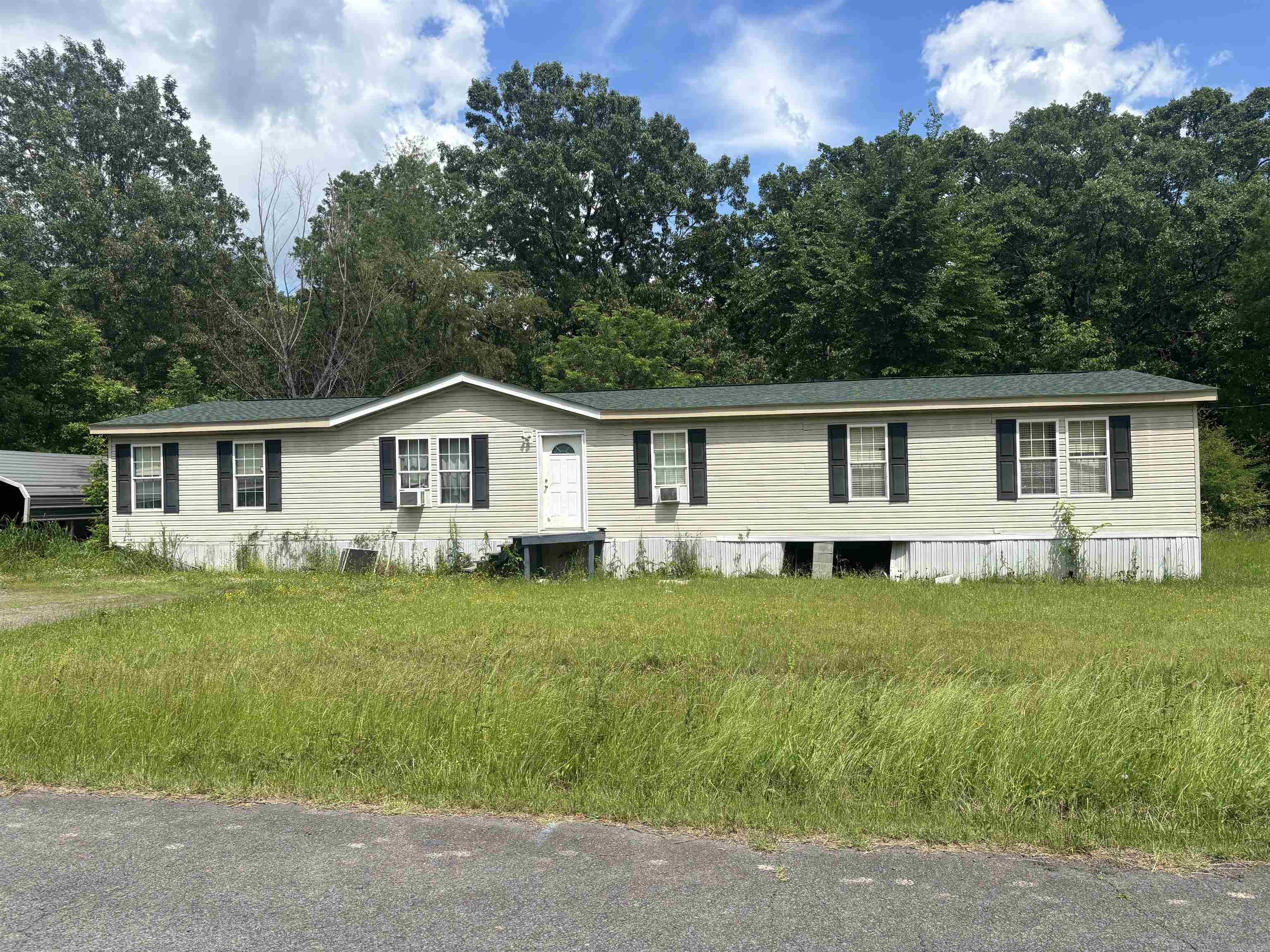This has 4 beds/1.5 baths that sits on approx 1 acre. You will find great space in this mobile home with 2 living areas. New roof in 2022. Being sold as is condition. Metal lean-to and window units won't convey. No sign will be in the yard