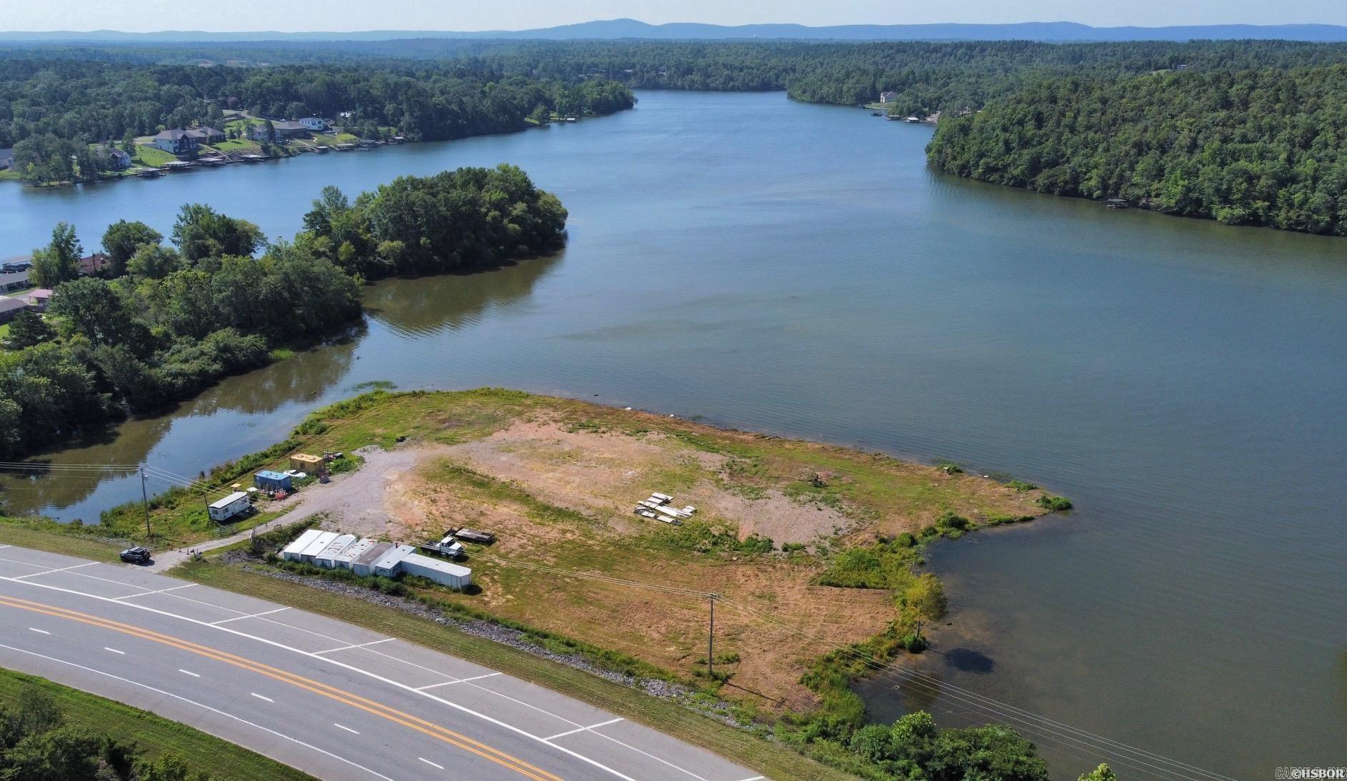 Prime development property on Lake Hamilton, consisting of approximately 2.5 acres with 1000' of lake frontage. Conveniently located off Albert Pike Rd. (Hwy. 270), the property lies outside the city limits which makes it suitable for residential or commercial development. The property has been cleared with over 300 loads of fill material brought in to elevate the site. City utilities available nearby. This property has incredible development potential!