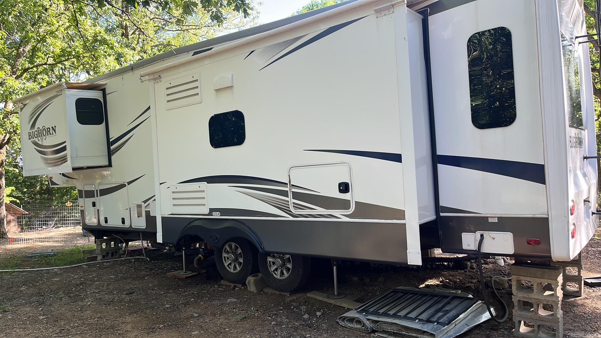 Quite the set-up!! Everything on the property, other than personal items will convey to the buyer, including the 2016 Big Horn 5th wheel RV. Fenced & cross-fenced for your fur babies. New well set-up, new septic, underground power, new storage building, all new fencing, furnace replaced in 2024-2025, fruit trees (apple & peach), lots of shade trees. Circle drive w/gated entrance. Make an appointment to see this unique property today!