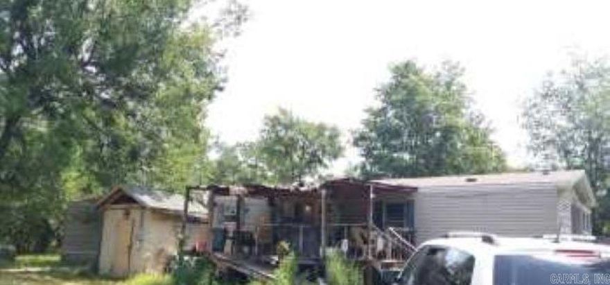 Investment opportunity! This 3-bedroom, 2-bath mobile home is being sold AS-IS for cash only. The home is in poor condition and needs major repairs or removal, but the property offers great potential for someone looking to start fresh. With utilities available and plenty of room to build or place a new home, this could be a great site for your next project.  Bring your vision and make this property your own!