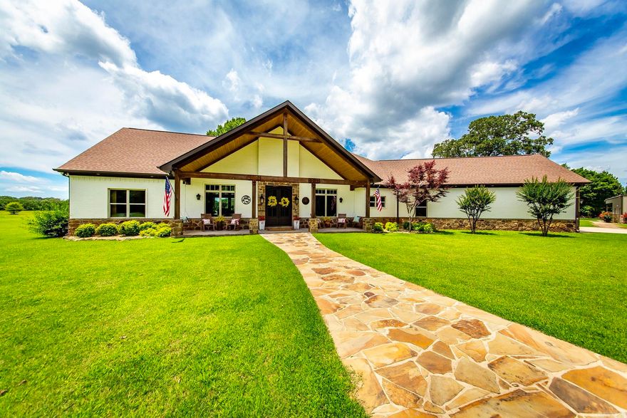 Stunning 4 bedroom, 4.5 bath, 3634 sq ft. home on a tranquil setting provides a magnificent family haven surrounded by beautiful pastures, woods, deer, other wildlife, and breathtaking sunsets. Detached 4th bedroom/bath located steps away. Custom bronze metal doors open to foyer, dining room and great room featuring a stone fireplace and 18 ft. cathedral ceiling. Foyer's ceiling and barndoor in Great Room are handcrafted from wood harvested from the ranch. Incredible chef's kitchen features an oversized island with honed granite countertop, 2 sinks, double oven, 6 burner gas stove, matching cabinet panels counter depth refrigerator. Walk-in pantry/saferoom adjoins kitchen. Master suite includes soaker tub, warming fireplace, large walk-in shower. Master closet opens to laundry room. Two spacious guest bedrooms w/ensuite baths, one has walk-in shower. Custom wood cabinets and bookcases compliment the office. Vaulted, covered back porch, wood burning fireplace and grilling area. 2400 sq. ft. metal shop with guest quarters, ensuite bath, mini split HVAC. Additional adjoining acreage is available for sale.  VIEW VIDEO!