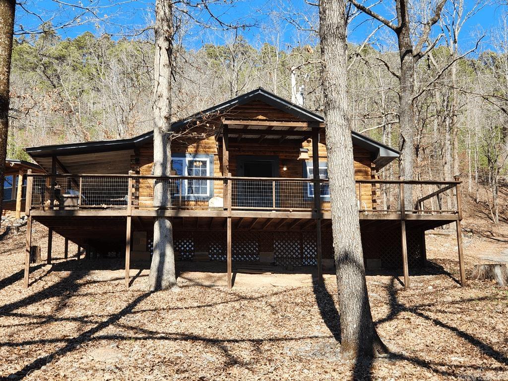 If you're looking for a bit of peace and quiet on the Caddo River then this may be the property for you! It includes three charming cabins nestled on 23 acres that border the National Forest on two sides with 1358 feet upwaters of the Caddo River bordering the property. You can sit on the porch with your coffee and enjoy listening to the river as you breath in the country air. With all the trees surrounding this property, it was a very private feel. There is a 41 x 30 shop with a concrete floor and roll up doors to house your ATVs, boats, or any storage that you may need. The property is located close to Albert Pike and Little Missouri Falls and is about thirty minutes from the picturesque town of Mena. This property has the potential to be income producing. You could live in the main cabin and rent out the other two or rent all three as an Air BnB or VRBO. There is also a small barn and very large fenced area that could work very well for a hobby farm. There is too much to mention everything this property has to offer. Call for your private showing today!