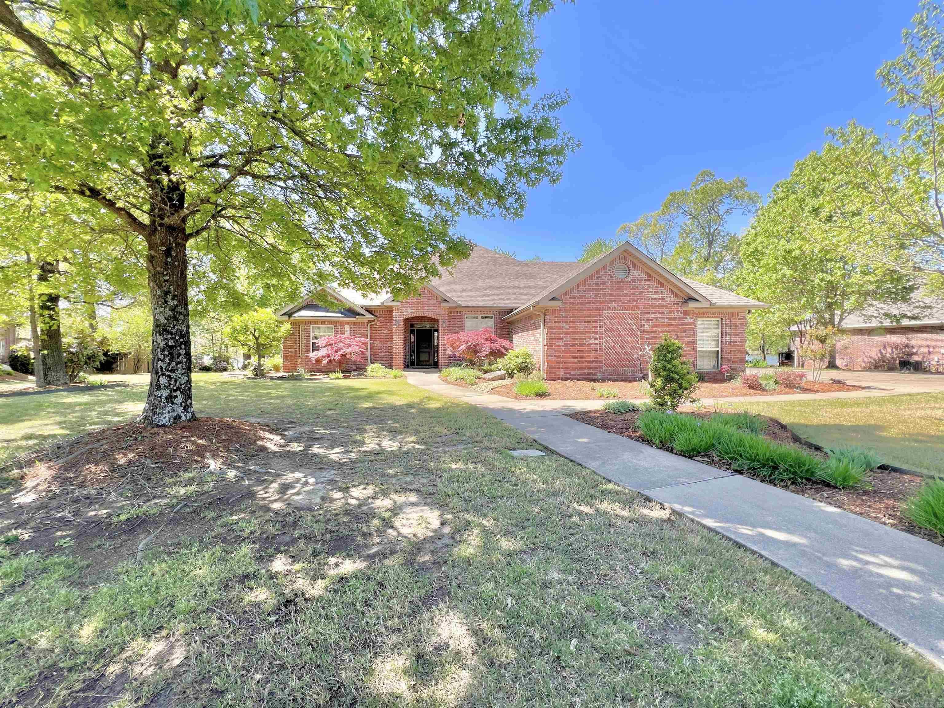Exquisite custom-built home with a peaceful lakefront view. Enjoy the picturesque landscaping as you approach the home. Step inside the large welcoming foyer and take in the 10 ft ceilings, wood floors, abundant windows, detailed trim and elegant lighting. The first floor provides the primary suite, guest room, living room and kitchen, dining, laundry and in-law quarters with full kitchen, living and ensuite with private garage. The second floor provides a bonus room, guest room with private balcony with lake views and bathroom with extra closets for storage. The main kitchen offers lovely cabinetry with pull out shelving and granite countertops. The bath in the in-law quarters has a jetted tub. The primary bedroom offers a beautiful view of the lake, private deck access, walk in closet and garden tub. Updates include new tankless water heaters and roof in '23. Tri-zoned HVAC with primary new in '23. There's a three-car garage for main home plus one car garage for in law quarters. This home sits perfectly on .70 acres. Enjoy the park like backyard with beautiful landscaping. Imagine enjoying the breeze off the lake and watching the ducks and geese cruise through cypress trees.