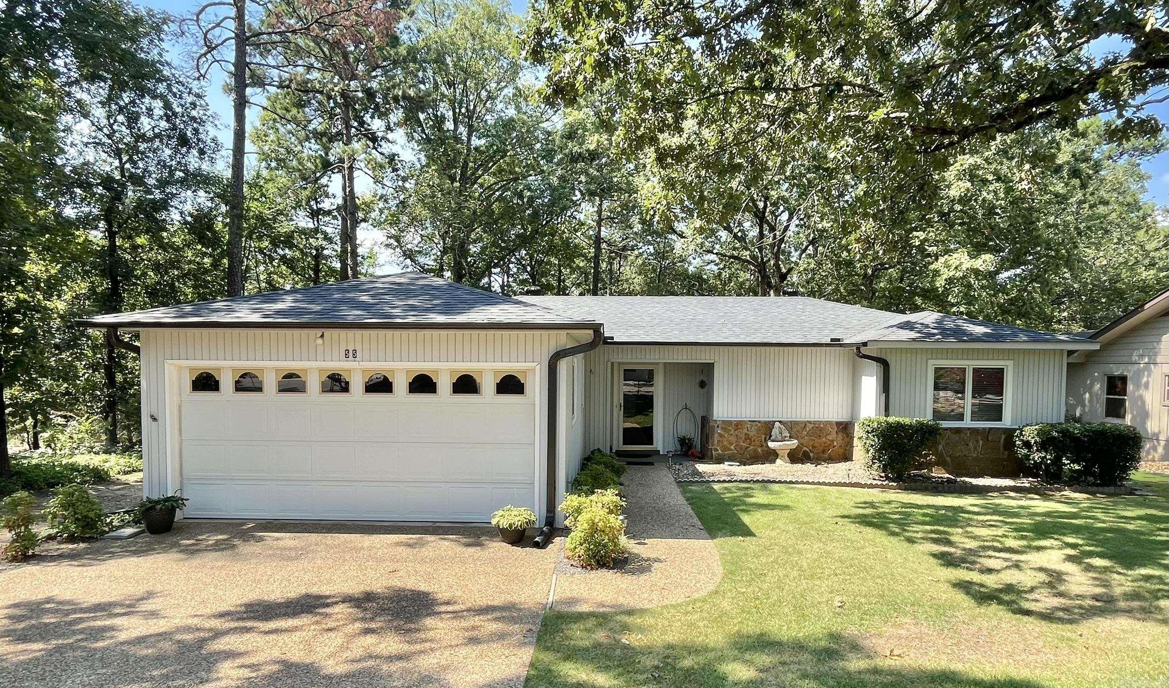 Come see this beautiful home. Whether it is your first home or your forever home this gem is amazing. This 2-bedroom and 2-bathroom home is so beautiful and cozy. New roof and leaf guards August 1, 2025, New HVAC 2024, New Garbage disposal 2025, Hot Water heater 2019, New floors and backsplash in kitchen. Wood burning fireplace. Master bedroom with bath and second bedroom next to second bathroom. A large Arkansas room looking at the beautiful nature and this corner lot. Three miles from the West Gate. Large separate 10X16 workshop with electric power in back. Two car Garage. The landscaping on this is beautiful.