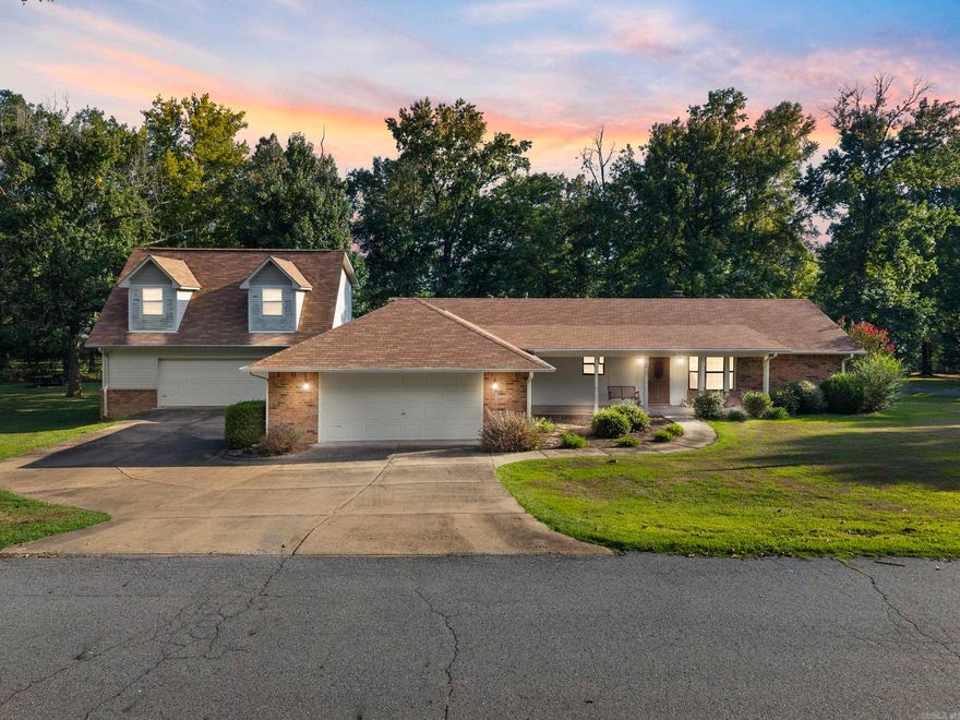 Well-maintained home on a corner lot in Vilonia offering 2 bedrooms and 2 bathrooms with a desirable split floor plan. The living room features a vaulted ceiling, creating an open feel. The property has been updated with a new roof, new HVAC systems inside and out, a new garage door opener, and a new trash compactor. The kitchen is efficient and functional, and the layout provides good use of space. The home sits on a well-kept lot with room to enjoy outdoor living. A large shop is located on the property, equipped with electricity, a sink, and plenty of space for storage, hobbies, or projects. Above the shop is an additional 651 sq. ft. apartment, not included in the home’s square footage, that includes its own bathroom and kitchenette. This makes an excellent option for an in-law suite, guest quarters, or a private space for a college student. The combination of updates, layout, and additional apartment space makes this property a unique find in Vilonia.