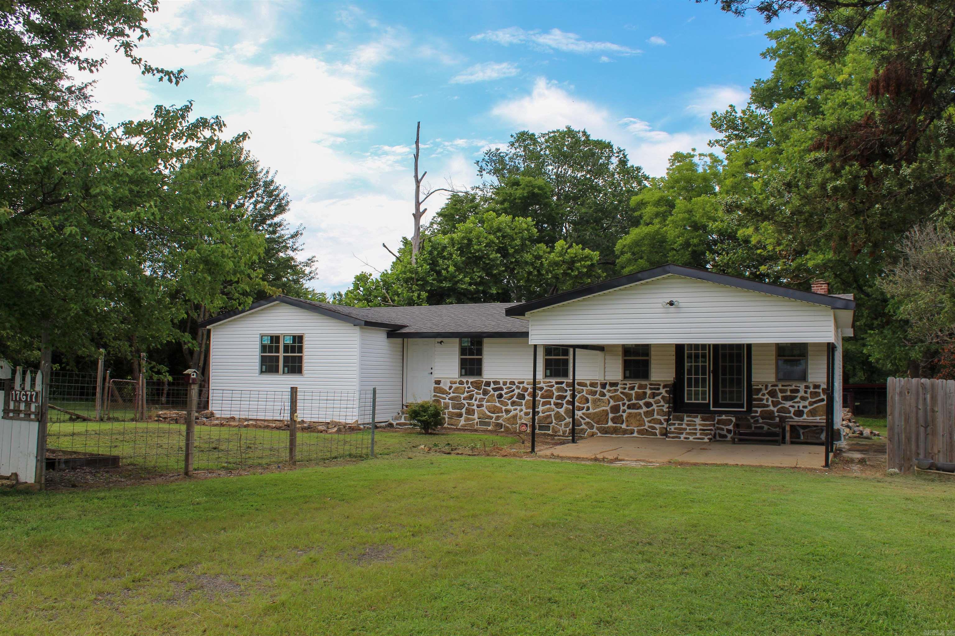 Experience the best of both worlds, peaceful country living just outside city limits while still being conveniently close to town. This beautifully remodeled home sits on a clear, level one-acre lot and is located just a few miles from downtown and less than 5 minute drive from the Dardanelle School District. The home features 3 bedrooms, 1 full bathroom, and a spacious open-concept layout where the living room, kitchen, and dining area blend seamlessly, creating a warm and inviting space. You'll also find a dedicated laundry area and a concrete carport for covered parking. One of the standout features of this property is the large outbuilding, offering endless possibilities for storage, a workshop, or hobby space. If you're looking for space, privacy, and convenience, this property checks all the boxes. Donāt miss your chance to own this well-maintained home with plenty of room to grow and make it your own! Call 479-324-2879