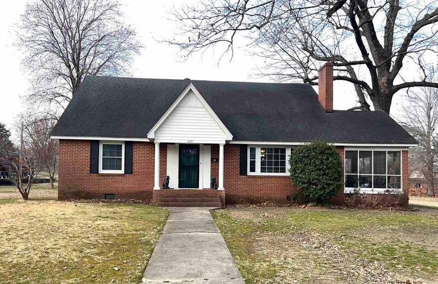 Welcome home to this beautifully maintained brick 5-bedroom, 2.5-bath property offering 2,599 square feet of comfortable living space on a spacious .48-acre corner lot. From the moment you arrive, you’ll appreciate the mature shade trees, timeless curb appeal, and pride of ownership throughout.  Inside, original hardwood floors add warmth and character, while the cozy fireplace creates the perfect gathering space. The lower level features 3 bedrooms and 1.5 baths, ideal for family living or guest accommodations. Upstairs, you’ll find two oversized bedrooms with generous space and flexibility and your 2nd full bath.  This home has been thoughtfully updated with a new AC unit and energy-efficient windows for year-round comfort and savings. Step outside to enjoy the screened-in porch or entertain on the deck overlooking the shaded backyard.  A detached two-car garage connected by a breezeway adds convenience and charm. Above garage, you’ll find a floored attic space offering excellent storage or the potential for a hobby area, workshop, or future expansion.  Meticulously maintained and move-in ready, this property offers space, updates, and classic style—all in one exceptional package