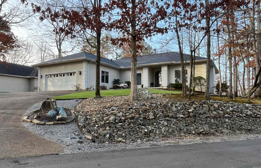 Overlooking scenic Lake Balboa in the heart of Hot Springs Village, better-than-new this home is perfectly perched on a hill to capture beautiful lake views & natural light thruout. Impeccably maintained 3 bdrm, 2 ba. offers approx. 2,125 h/c sq ft of refined living space designed with comfort & quality in mind. From the moment you enter, you’ll notice the exceptional craftsmanship, custom built-ins, & bright open interior that create an inviting yet sophisticated atmosphere. Features include: a woodburning fireplace, built in real wood white maple custom cabinets. Recent upgrades include a new arch. shingle roof ensuring value and peace of mind, Kitchen & Bathrooms have also been upgraded. Additional features: Lrg Primary walk- in shower, lrg kitchen with granite counters incl. a lrg island & pantry, builtin desk, undermount Silgranit Sink, pullouts & under cabinet lighting. 9' & 10' Ceilings, Faux Walls, Arched Doorways. Energy saving with 6" walls, low"e" casement windows, wired for a whole house surge protector and a high eff. Trane h/a unit. The home continues to impress outdoors with prof. designed landscaping & includes a sprinkler system for flower beds. Price is $408,700