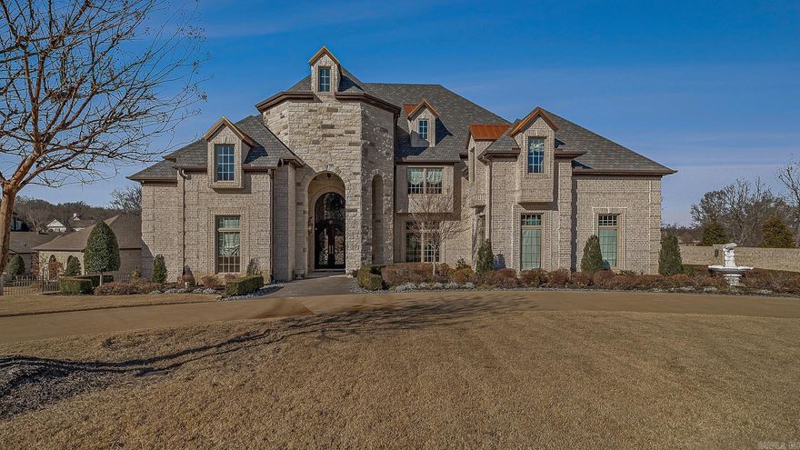 Luxury home with striking European architecture overlooking the 14th hole of Ridgepointe Golf Course. The elegant brick exterior is enhanced by stonework, arched elements, and distinctive copper roof accents that create unforgettable curb appeal. Inside, a grand entry and dramatic spiral staircase introduce beautifully scaled living spaces filled with natural light, soaring ceilings, and refined finishes. The chef’s kitchen is designed for both function and style, featuring premium Thermador and Sub-Zero appliances. The main-level primary suite offers a private retreat with a spa-inspired bath and generous walk-in closets. Each additional bedroom includes its own ensuite bath and walk-in closet, ensuring comfort and privacy throughout. Three fireplaces add warmth and character, while the dedicated movie room and game room provide exceptional spaces for entertaining. Professionally designed landscaping completes this remarkable Ridgepointe residence.