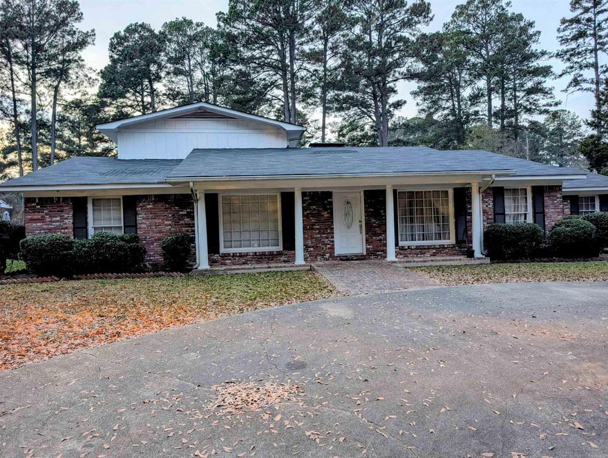 This unique property located in the Berg Addition boasts 5 bedrooms, 2 baths, 2 huge family rooms, formal living & dining room. There is a woodburning fireplace in the front family room for those cozy evenings. The primary bedroom is located upstairs with a balcony that overlooks the brick patio/courtyard and spacious back yard. Wrought iron gates open for parking in the rear of the home. You must see this jewel to appreciate it!