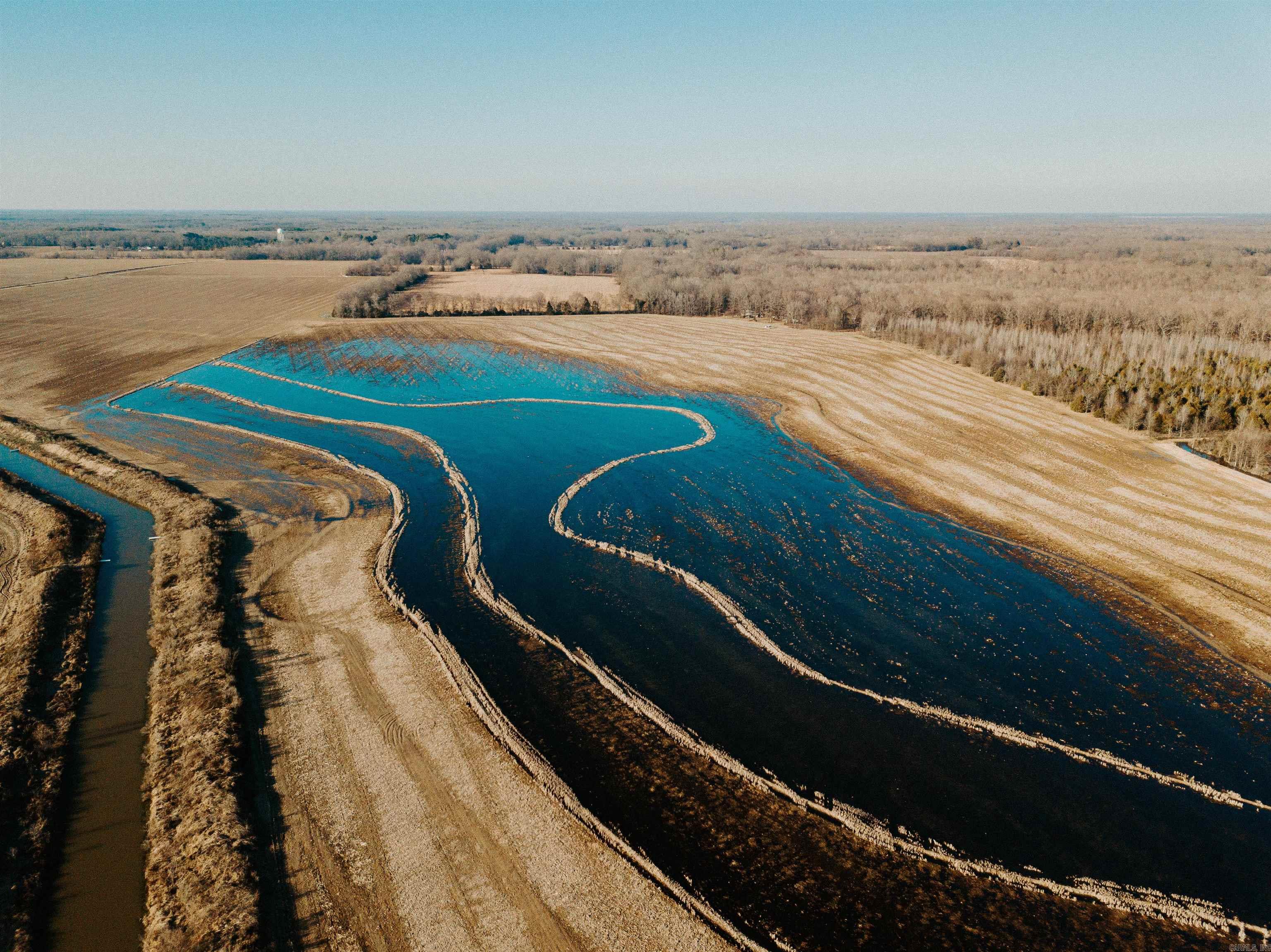 This 818 acre farm is located in Casscoe, AR and has 791.88 tillable acres! In addition to the farm acreage, there are 3 farm/equipment buildings; two pole barns and one enclosed shop building. All are in good working condition and actively used in the current farming operation. There are 7 wells in good condition on this farm; four electric and three diesel. In addition, there are two re-lift pumps. There are two tailwater ditches in place that capture excess water run off from irrigation. The excess water is then available to be reused by re-lifting it back onto the farm. This farm is known to be a high yield farm and is set up to be a successful farming operation. The Casscoe 818 is also less than one mile from the White River Refuge, resulting in some incredible waterfowl hunting! Mallards return to the resevoir/smartweed hole in large numbers every year. Specks and snow geese also frequent this farm in large numbers. It is not often that you can find a large tract like this that provides such a high amount of tillable ground with proven, high quality hunting. Come take a look while this one is still available!