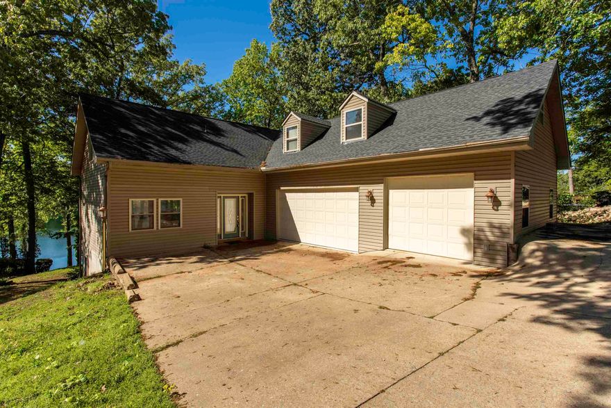 Beautiful 3BR/3 bath home on Lake Thunderbird! 3 car garage/shop with extra parking. Prime location on Lake Thunderbird, on quiet cul de sac. Upstairs you will find the primary suite with balcony view of the lake. Large primary bathroom has 2 pedestal sinks, soaking tub and shower. Laundry facilities on this level for convenience. 2nd Bedroom also on this level with large walk in closet. All new flooring upstairs. On the main level there is another bedroom with walk in closet and private bath. Hardwood and tile flooring in living room, dining room and kitchen. Lower level walk out basement has another area that could be office or sewing rm, another bathroom, family room with tile floor. Separate room with sauna, plus storage area. Outdoor areas to enjoy include deck, patio and seawall area perfect for fishing or soaking up the sun. Prime lakefront spot on Thunderbird.