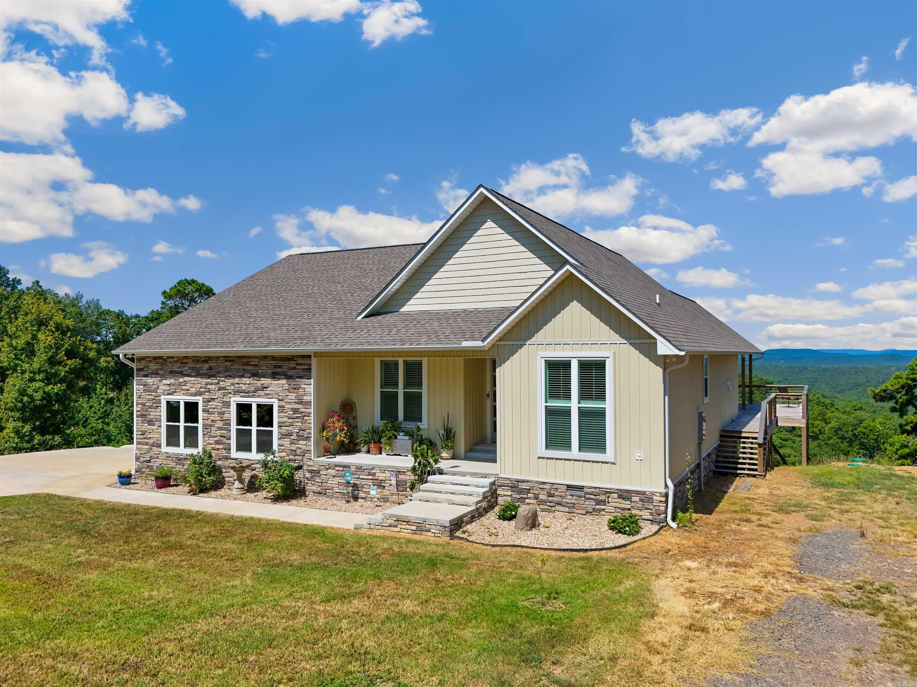 Stunning 2023 custom home with mountain & lake views on over an acre! Experience the perfect blend of comfort, luxury, and functionality in this beautifully crafted home, nestled on a serene dead-end street with breathtaking mountain and lake views. Situated on 1+ acre, this property features a spacious 30'x74' heated and cooled shop with 3 exterior bay doors and 1 interior bay doorāideal for RVs, boats, hobbies, or a small business. Inside the home, you'll find high-end finishes throughout, including luxury vinyl flooring, quartz countertops, a sleek linear fireplace, and 9' ceilings. Enjoy year-round energy efficiency with spray foam insulation (including ac/heat ducts) and a tankless water heater. The kitchen and master bedroom are fitted with remote-controlled shutters for both convenience and privacy. The master suite also includes a safe room discreetly located in the walk-in closet. Storage is no issue with ample space throughout the home, and the covered back deck offers a peaceful retreat to soak in the views. Check out links for 3D and drone tours.