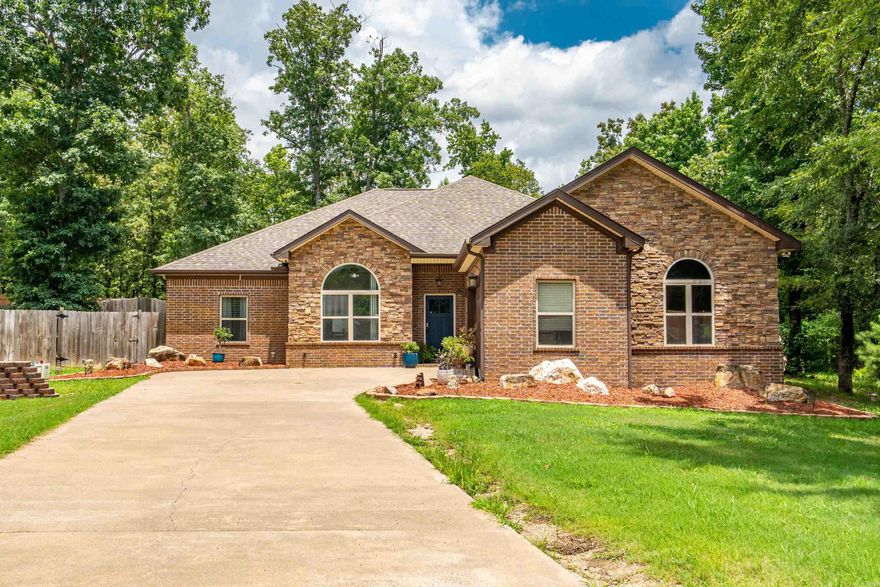 Stylish and inviting, this 3-bed, 2.5-bath home sits on 1.34± acres in the sought-after Lake Hamilton School District.  A dedicated home office easily converts to a 4th bedroom.The living room features striking vaulted wood ceilings, and the spacious primary suite offers a walk-in closet, double vanities, jetted tub, and a large walk-in shower. Enjoy the fenced backyard with a covered patio and fire pit—perfect for entertaining or relaxing. This property blends comfort, space, and outdoor living—schedule your showing today!