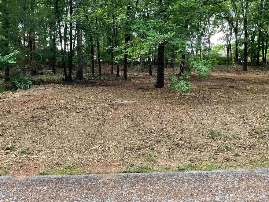 Exceptional dual-frontage property in Eden Isle offering a rare blend of privacy, convenience, and proximity to premier Greers Ferry Lake and golf amenities.  Situated on 0.74  acres with access from Rock Ledge Rd and Sugar Maple Rd, this property is nestled in a peaceful setting just minutes from Eden Isle Marina and Red Apple Inn and Country Club.  Ideally suited for a custom residence or retreat setting, with all utilities in place including public water, sewer, natural gas, electric, and cable.  Property enhancements in progress, with additional imagery forthcoming.