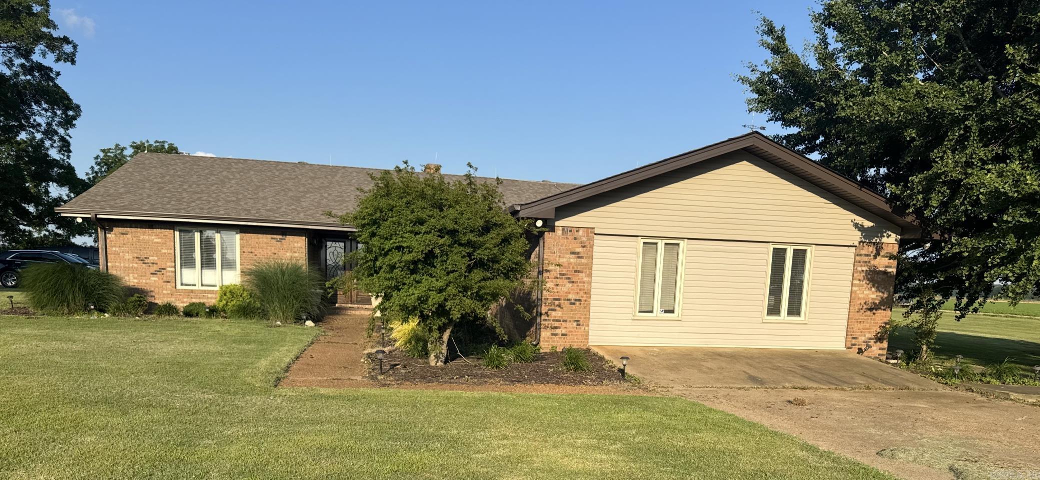 This charming home offers the perfect blend of country living and convenience, located just minutes from town and within the desirable Wynne School District. Inside, you'll find a large family room ideal for both relaxing and entertaining, as well as a spacious theatre room. The home also features a dedicated office space with a separate entry, perfect for those who work from home or need a quiet area for study. Outside you will find a new covered patio with stamped concrete, as well as a spacious 60 x 80 shop perfect for storage or projects. Originally built as an airplane hangar, the shop includes large folding doors on one end and a roll-up door on the other end. You need to see this home!