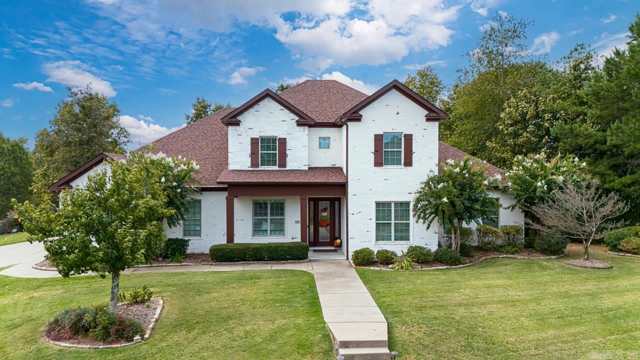In coveted WLR's Woodlands Edge, this custom-built entertainer's paradise has it all! Beautiful lime-washed brick home sits on corner lot featuring greenspace & an iron-fenced backyard oasis to unwind in including cov'rd patio, uncovered flagstone patio w/firepit & nestled deck w/hot tub built 2023. Luxury & functionality converge in this open plan, high ceilings, spacious bedrms, media/gamerm, sunrm, office/exercise room, sparkling hardwoods & attention to detail. Relaxation & view of nature await in the cozy sunroom w/stone FP/gas logs. Awesome updated chef's kitchen w/lg walk-in pantry & all new appliances 2023 including gas range & double ovens. Eat-in kitchen w/butler's pantry/wine frig & adjoining dining room making it ideal for gatherings. Primary & guest bedrm on main. Primary features fabulous dual vanities, walk-in shower, separate tub, 2 walk-in closets, office/exercise room. Guest bedrm has direct access to updated bath featuring new vanity, faucet, mirror & toilet. Many updates: roof 2022, leaf guard gutters 2023, LED lighting thruout, incredible laundry, convenient mud/drop area, craft room off oversized three-car, side-load garage. Come see!
