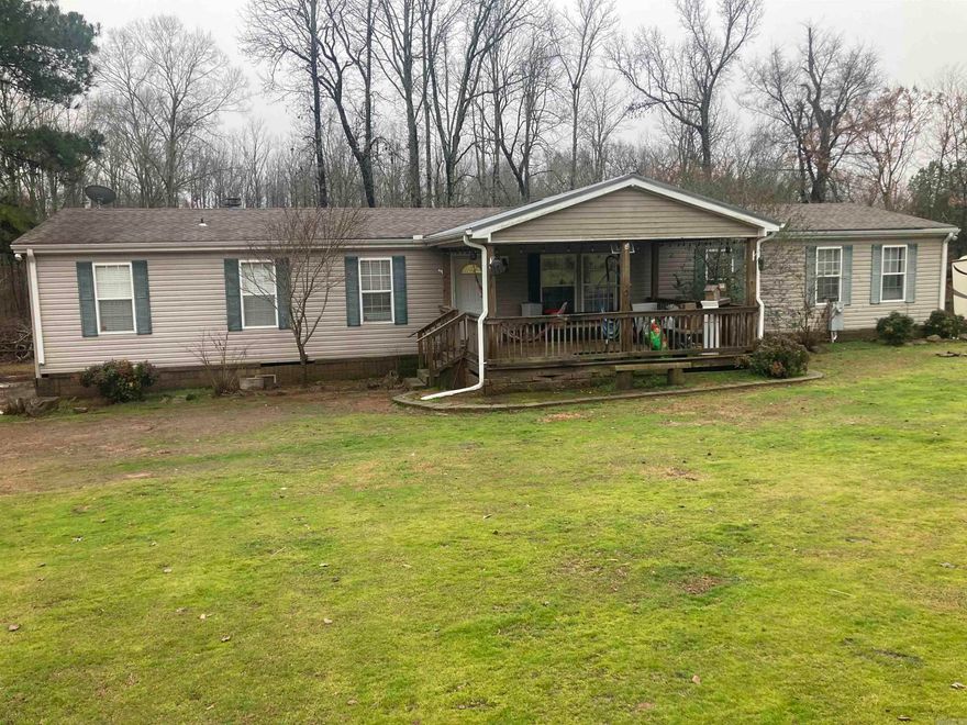 This 4 bed, 2 bath split floor plan home offers 2 living areas (one with wood burning fireplace), 9x12 office nook in master bedroom, separate shower and tub (master), 2 closets a and vanity sitting area (master). The home has a dining area and a bar to accommodate several people. The front porch is covered for seating out of the weather and the large back porch overlooks your very own shop/chicken coop. There is also a 12x20 metal building with roll up garage door. The yard is completely fenced and has a gate entrance with keypad. The shingled roof was replaced in 2019.