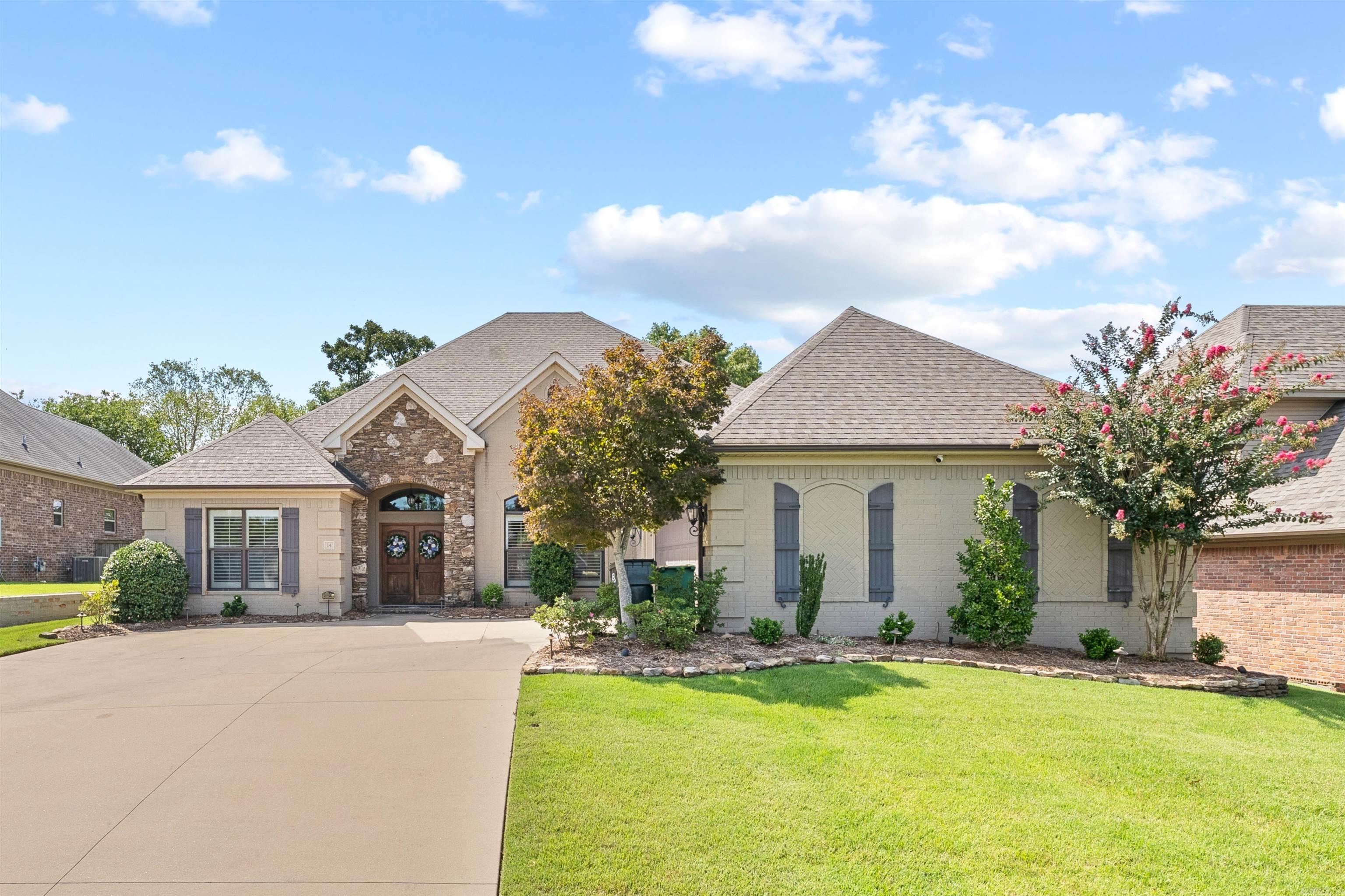 Welcome to this impeccable 4-BR, 2-BA home, where timeless style meets modern comfort. You are greeted by an open-concept living space with soaring 11' ceilings. The home's elegant & clean aesthetic is enhanced by custom plantation shutters, creating a bright and airy atmosphere.The spacious kitchen is a chef's dream, beautiful wood-stained cabinets, granite, & large island, perfect for meal prep or casual dining. The adjacent living area includes a convenient wet bar with ice maker, ideal for entertaining. Recent upgrades include a new gas fireplace with remote & new light fixtures. Enjoy a private retreat in the oversized primary suite, which is separate from 3 additional bedrooms. The primary BR features new hardwood floors and is large enough to easily accommodate a sitting area or office. The huge walk-in closet also has new hardwood floors. The backyard is an extended outdoor living area, perfect for game nights and entertaining! Easily accessible from 3 adjacent rooms, creating a seamless indoor/outdoor flow for year round enjoyment! Complete with a built-in grill & prep area, new outdoor ceiling fans & speakers. This pristine property is ready to WELCOME it's new owners!!