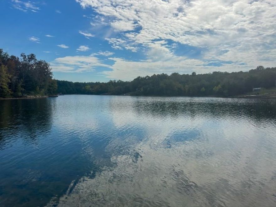 PRIME 1-ACRE LAKEFRONT LOT: 150+ FT FRONTAGE IN CHEROKEE VILLAGE, AR. This is an exceptional opportunity for custom home builders, investors and anyone looking to build a dream home, to secure a rare, spacious parcel on desirable Lake Chanute. Featuring over 150 feet of direct lake frontage, the lot's gentle slope is ideal for efficient construction, perfectly accommodating a sought-after walk-out basement design with year-round views of the spring-fed, no-wake lake. Essential utilities—including water, electric, and high-speed Next internet—are readily available at the road, significantly reducing your development timeline and costs. Located in an amenity-rich community, future homeowners will enjoy access to two golf courses and seven lakes, enhancing the value of any custom home built here. Secure this premium canvas for your next masterpiece. Contact us for a full property brief and to schedule a viewing.