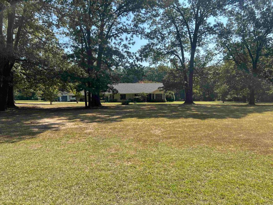 Well-maintained and move-in ready, this charming three-bedroom, two-bath home sits on 3.75 acres of beautifully manicured land. Inside, you’ll find a spacious living room with a cozy gas fireplace, a separate dining room that could easily serve as an office, and a bright breakfast area. The large master suite provides plenty of comfort and storage, while generous closets are found throughout the home. Tile flooring adds both style and durability, and a separate laundry room with sink makes household tasks a breeze. Outside, enjoy a detached two-car carport and a large shop with three roll-up doors — perfect for vehicles, equipment, or hobbies. This property offers the ideal blend of peaceful surroundings, functional spaces, and practical amenities.